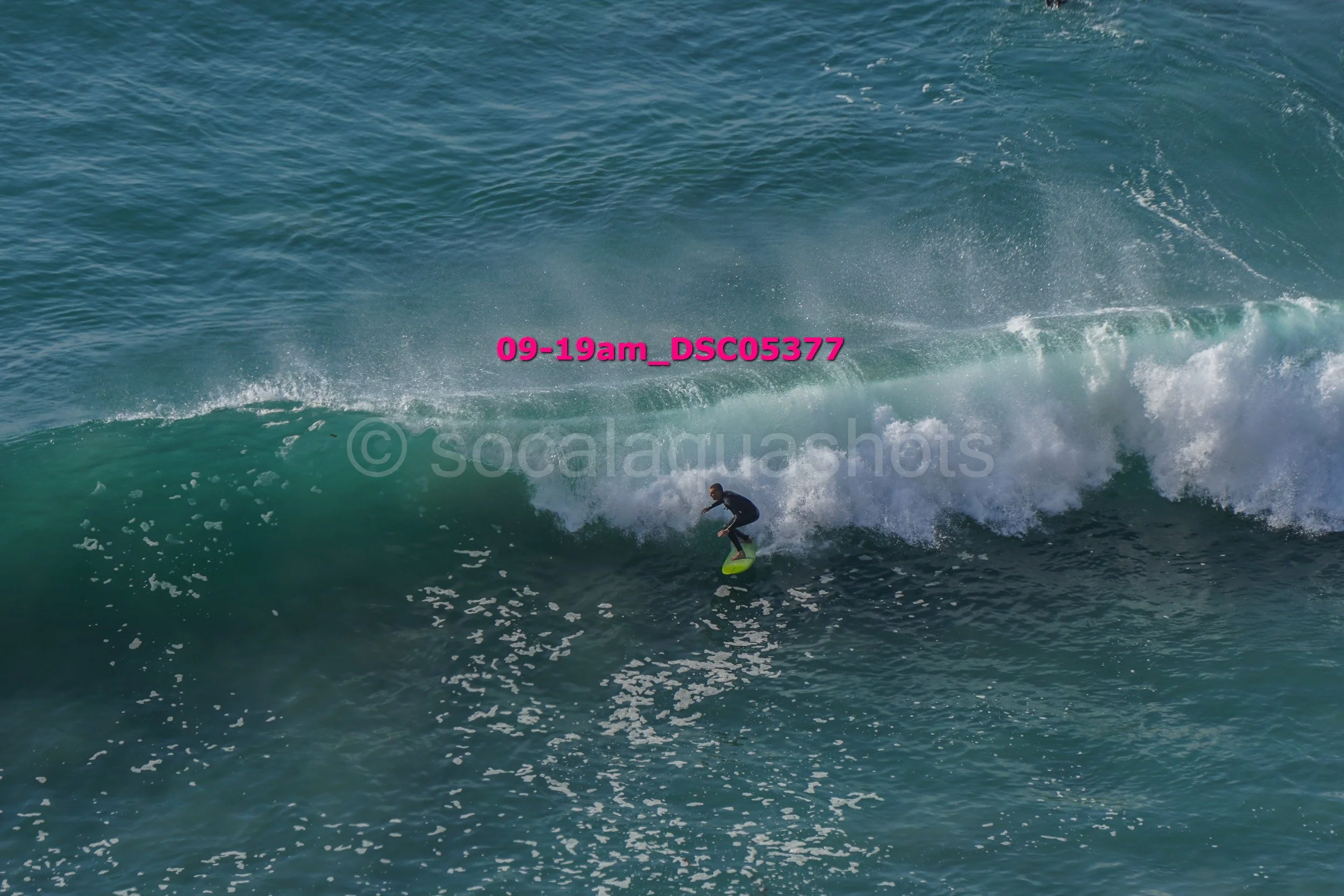 A person surfing on a wave in the ocean.