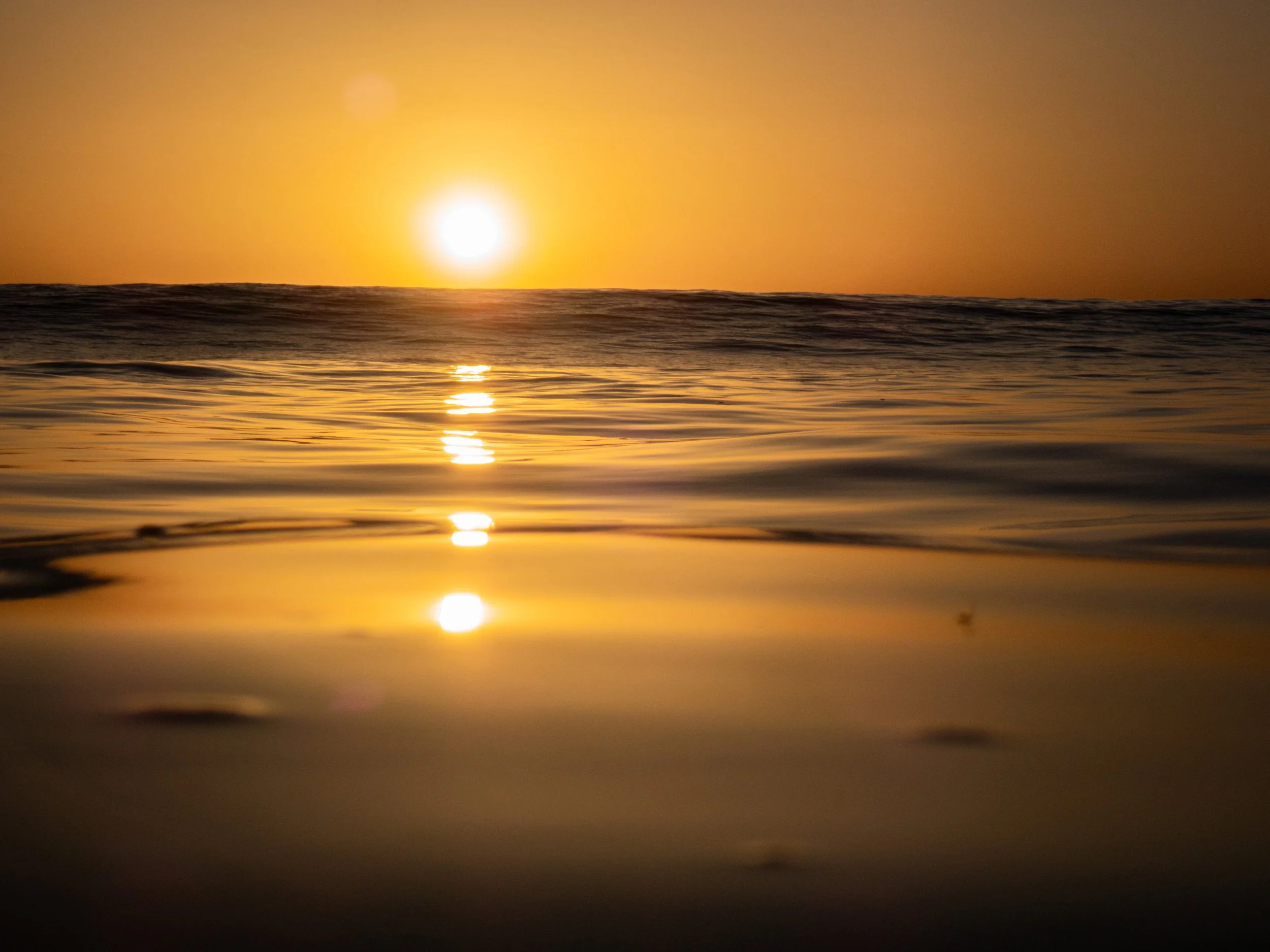 Sunset over the ocean with a reflection on the water