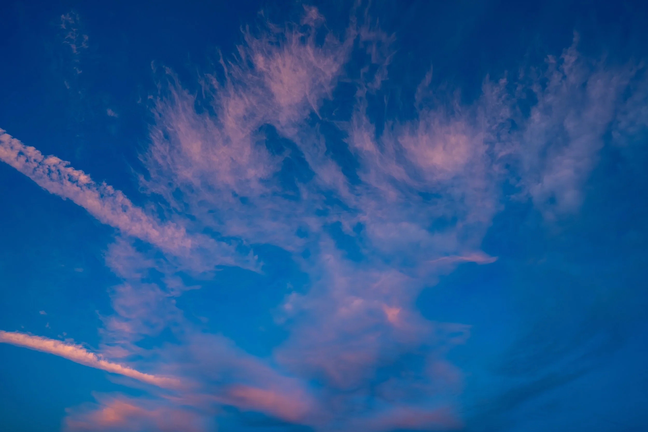 Sky with pink and purple clouds during sunset or sunrise.