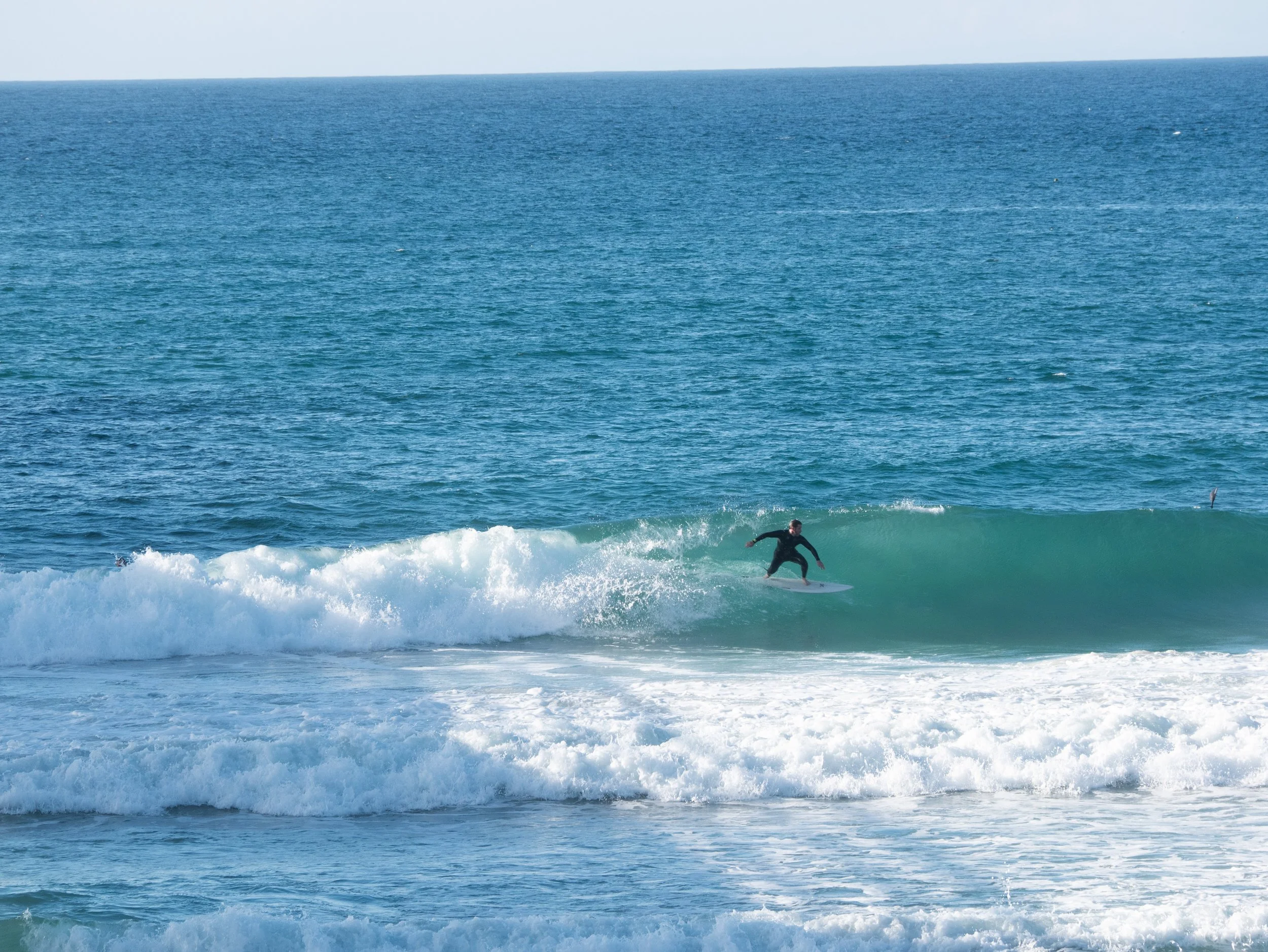 A person surfing on a wave in the ocean