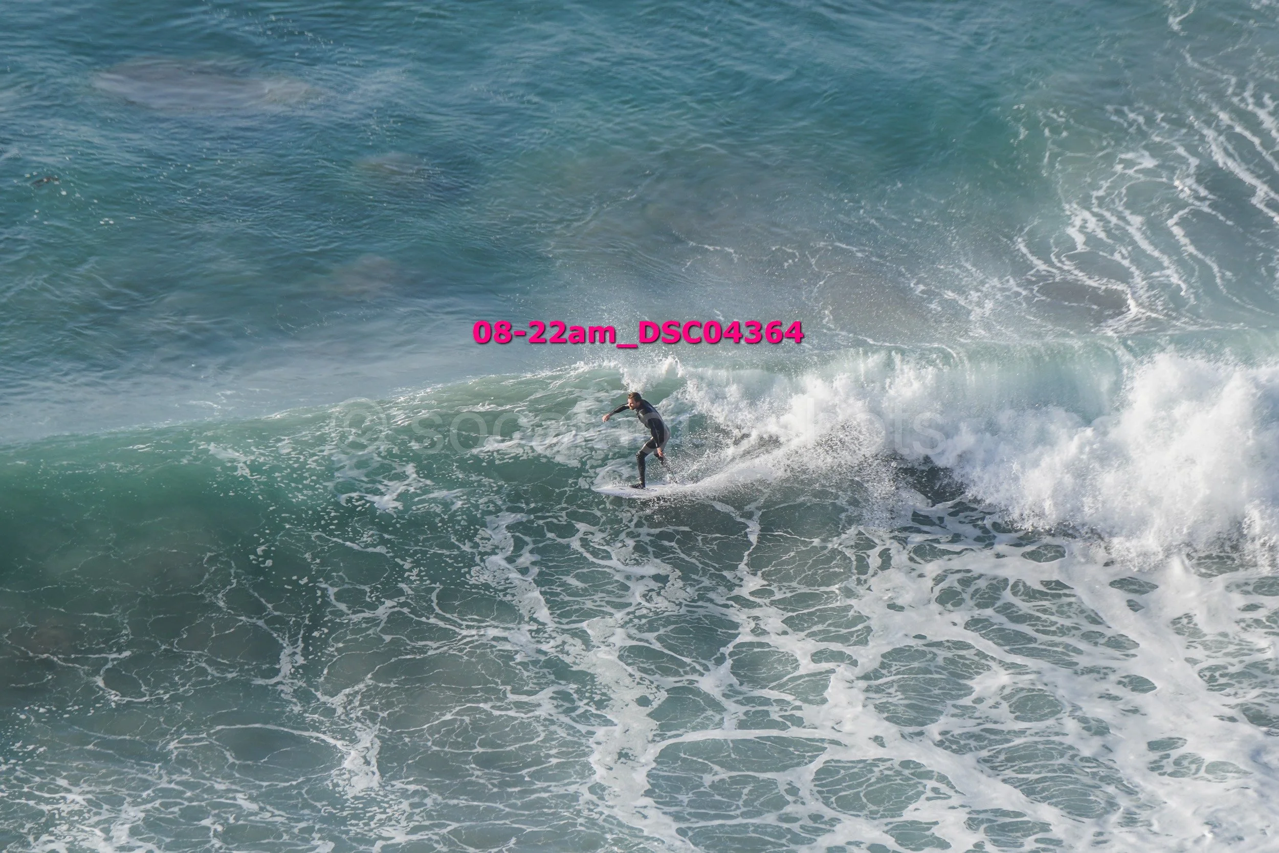 A person surfing on a wave in the ocean