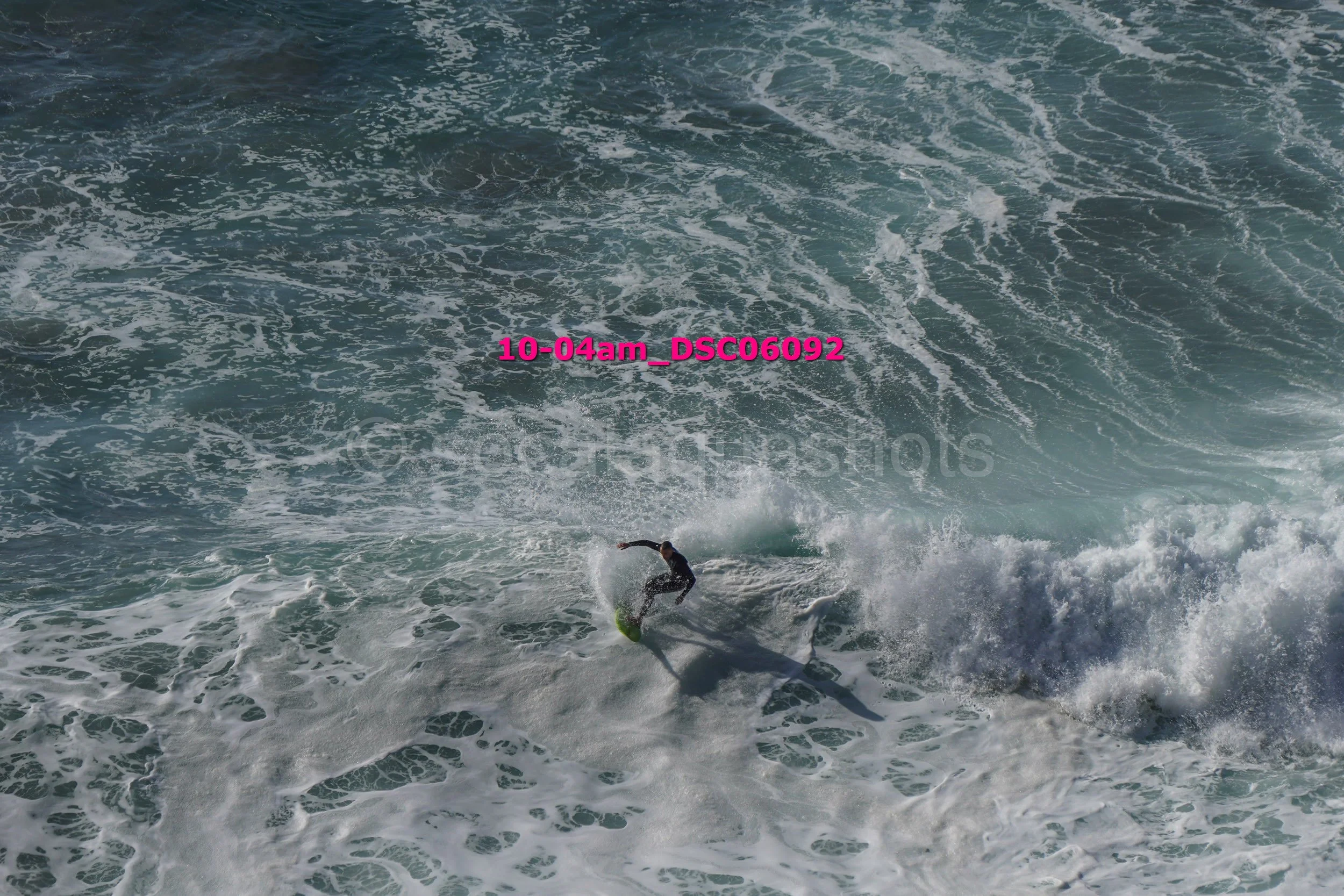 A person surfing on a wave in the ocean.