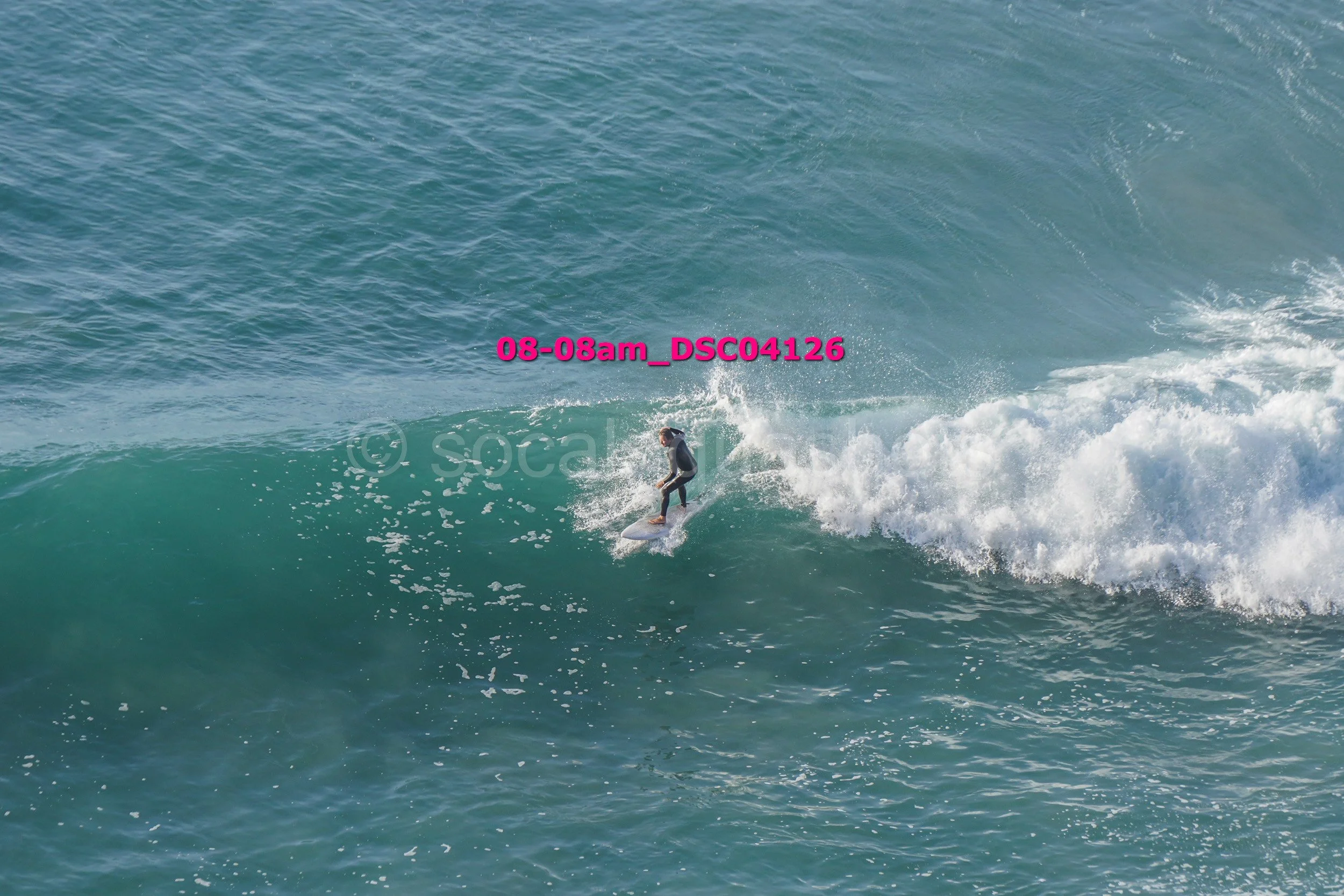 A person surfing on a wave in the ocean.