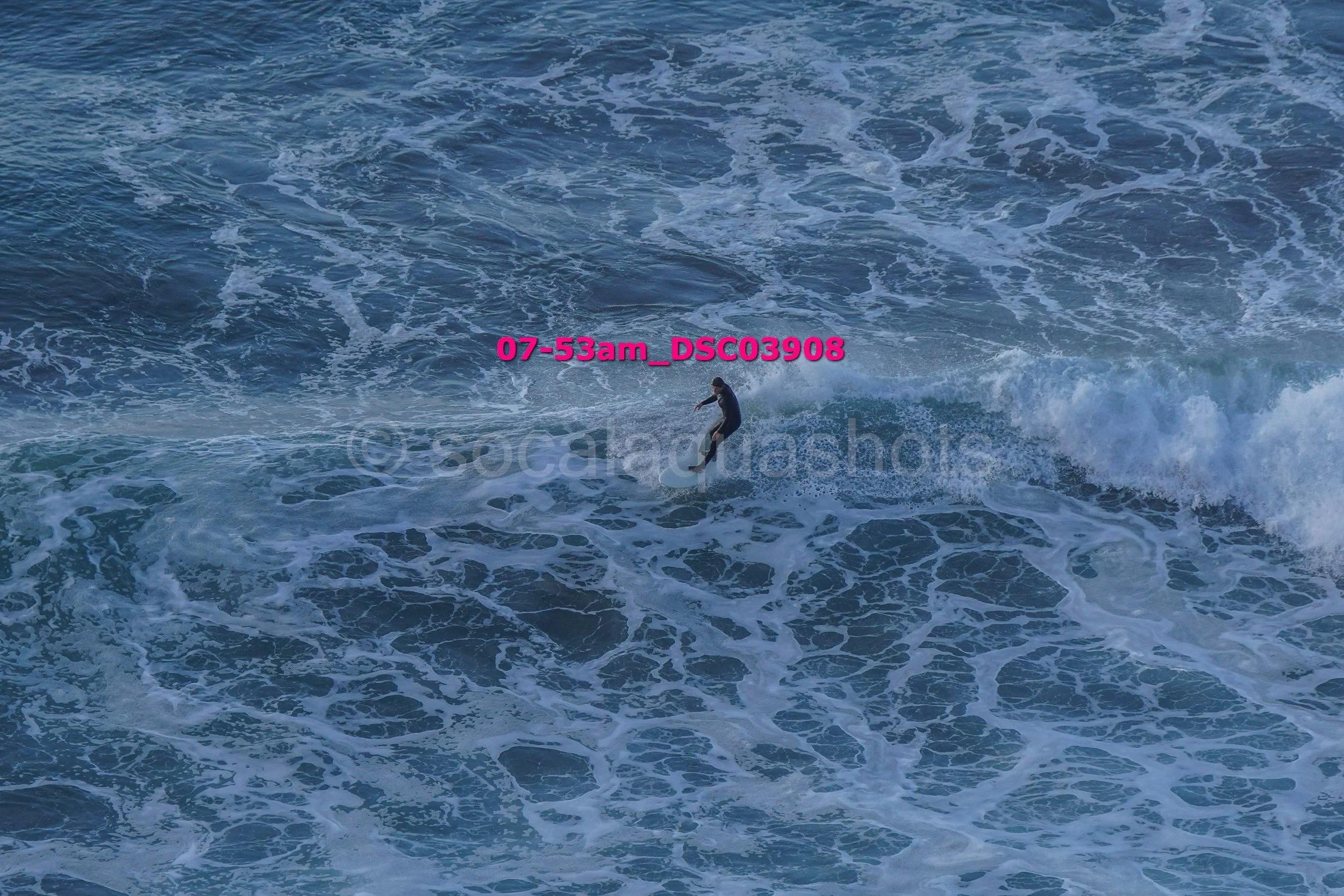 A person surfing on a wave in the ocean