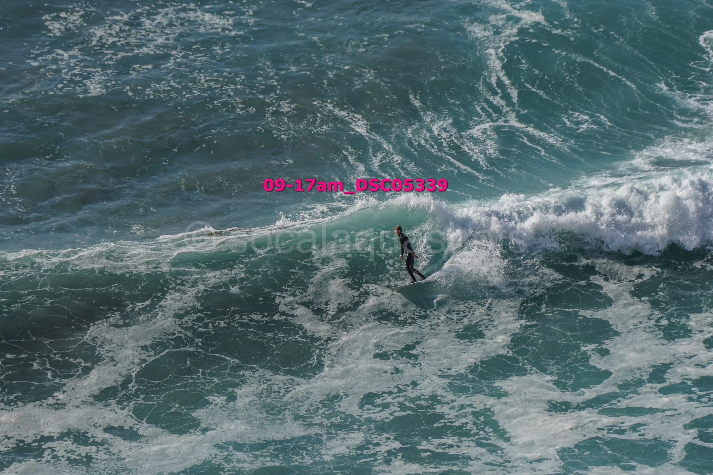 A person surfing on a wave in the ocean.