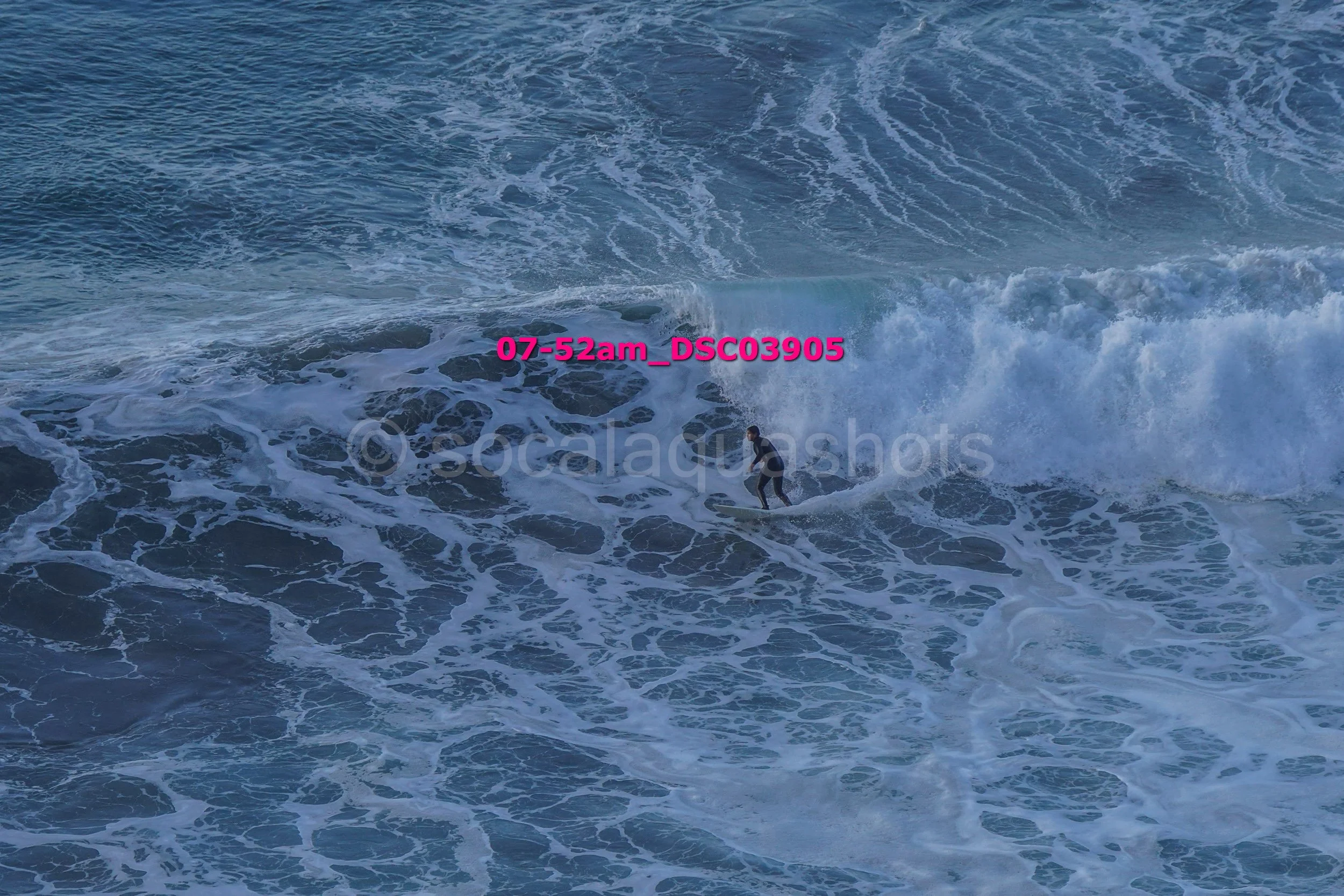 A person surfing on a wave in the ocean.