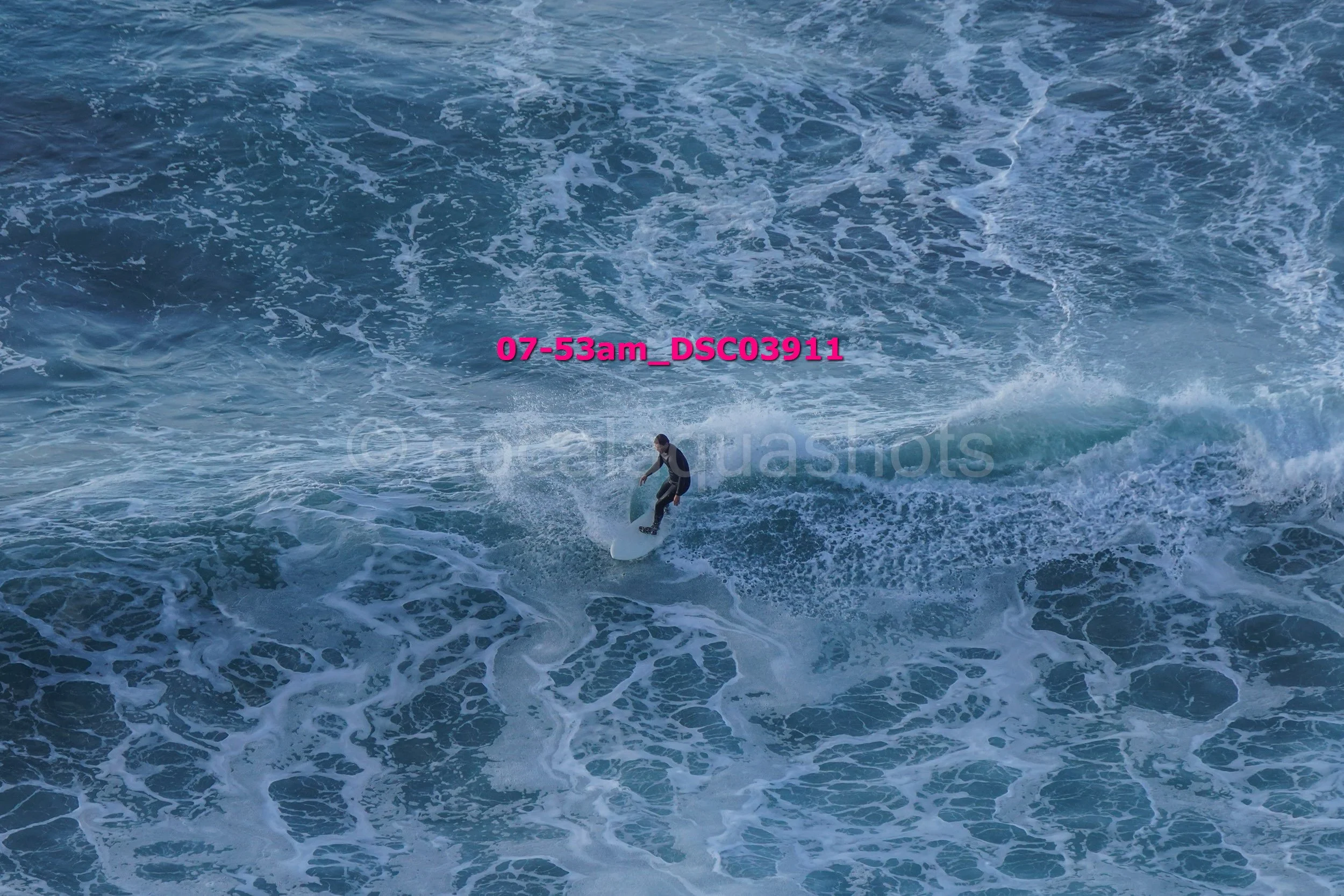 A person surfing on a wave in the ocean
