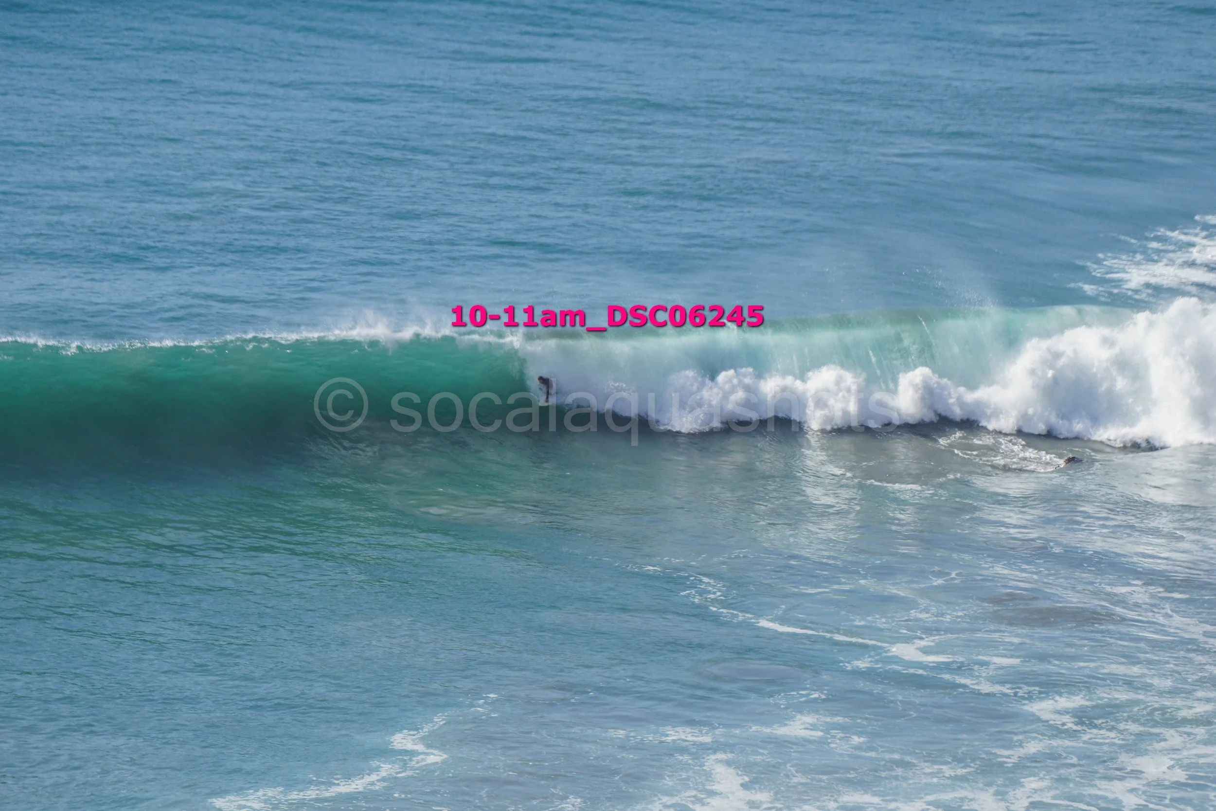 A person surfing on a wave in the ocean.