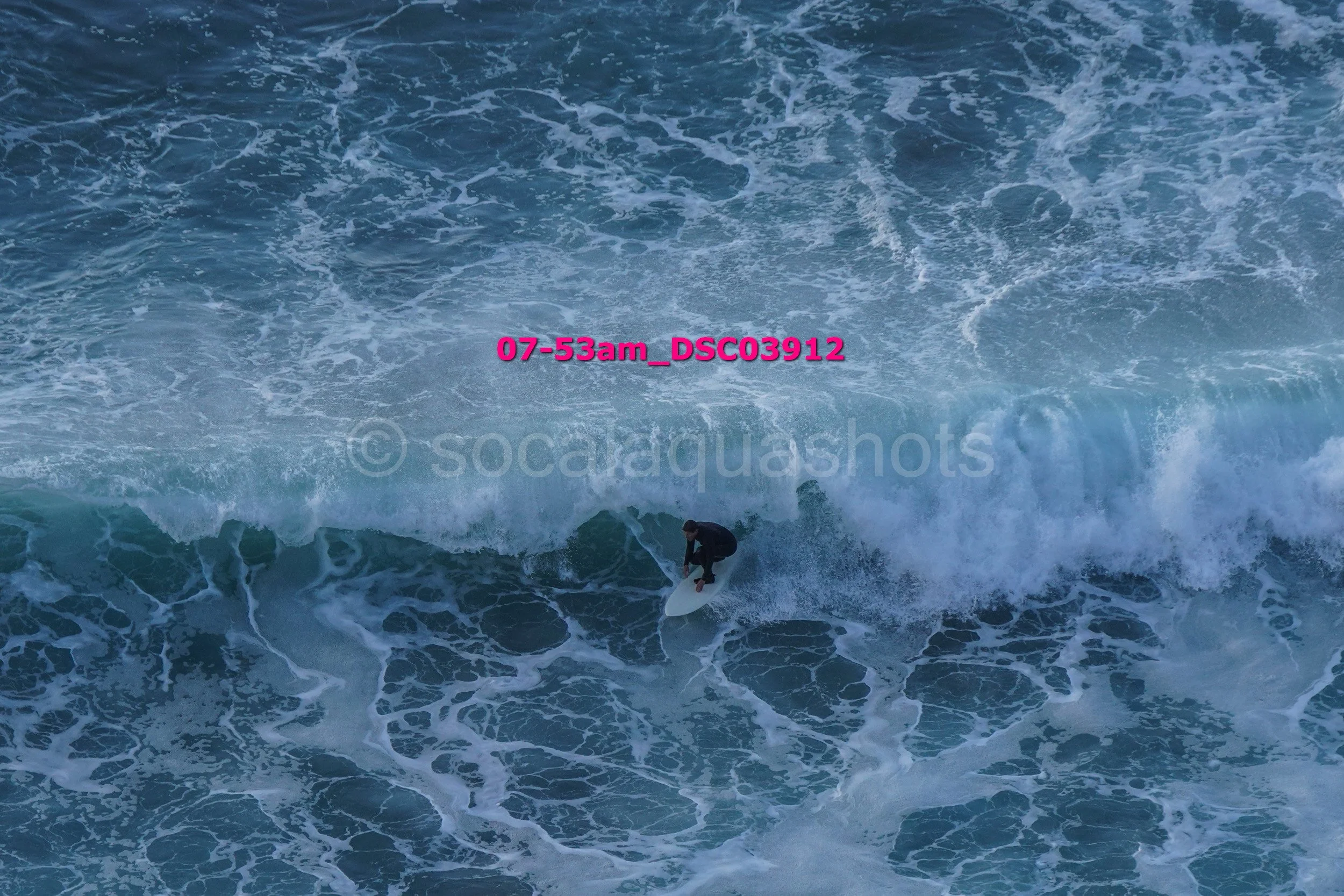 A person surfing on a wave in the ocean.