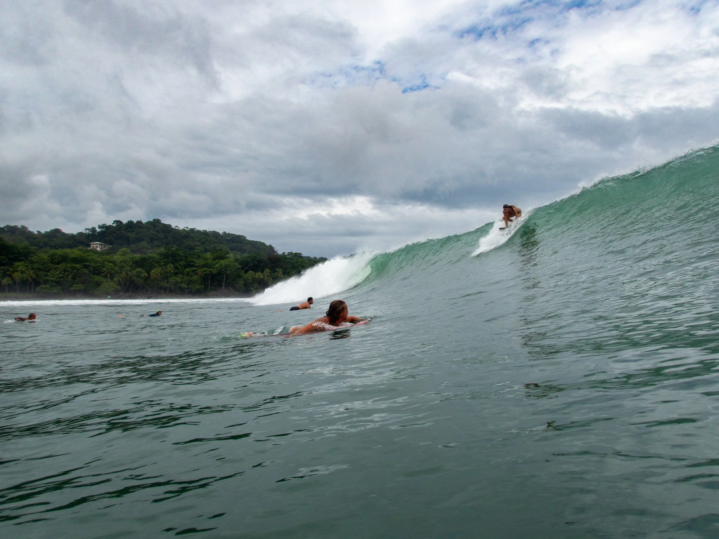 Surfers in ocean with large wave