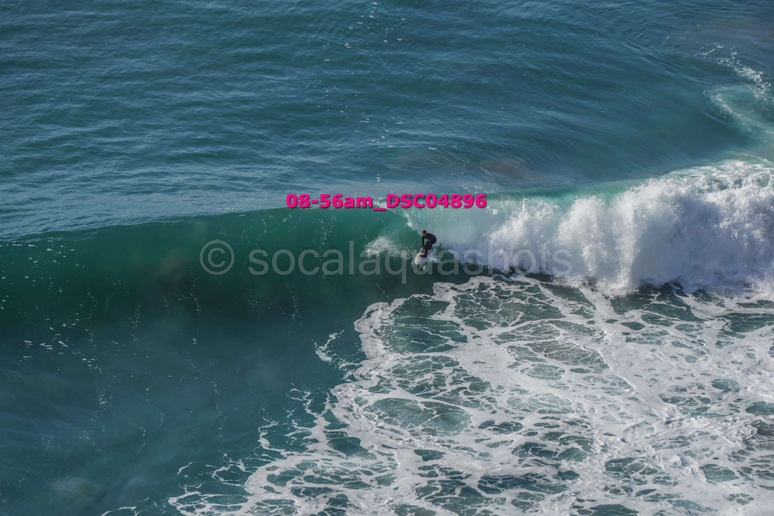 A surfer riding a large wave in the ocean.