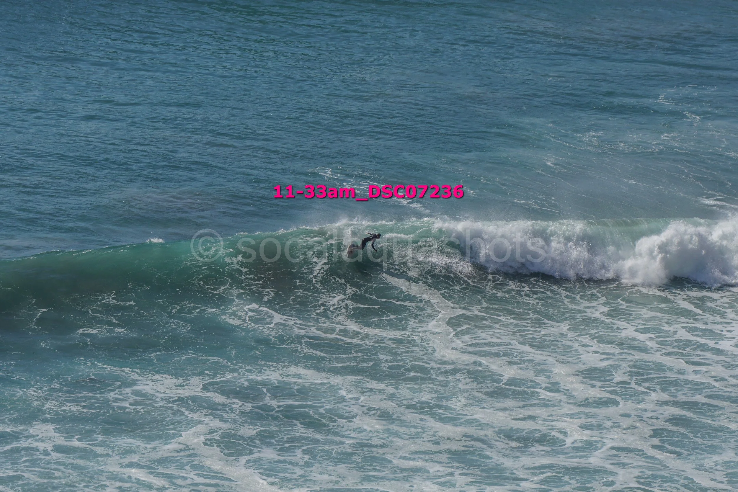 A person surfing on a wave in the ocean.