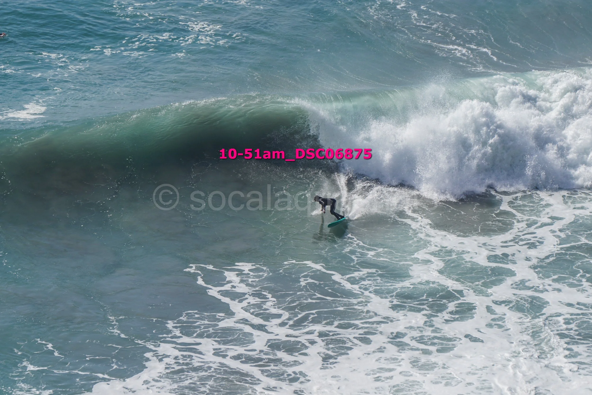 A person surfing on a wave in the ocean.