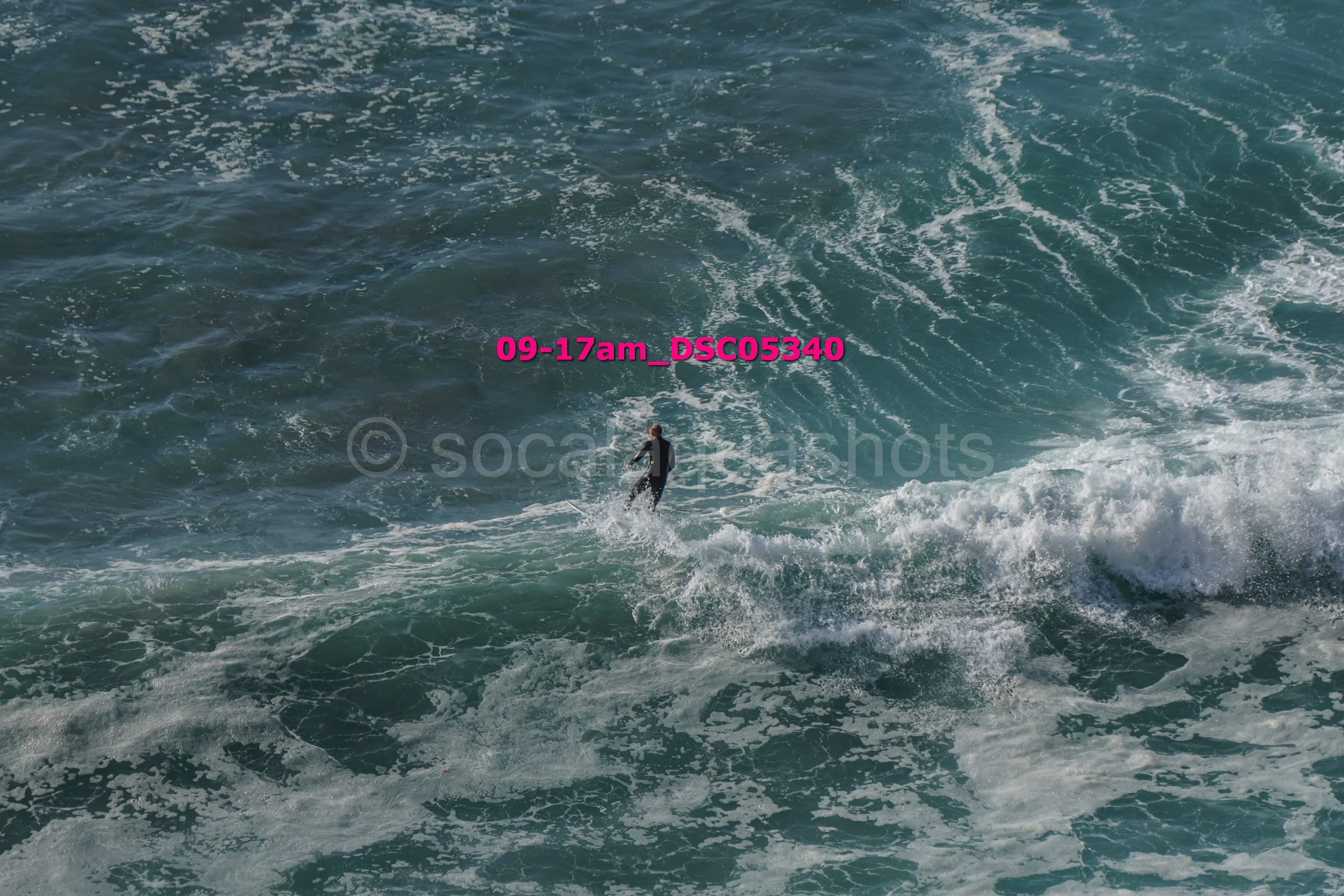 A person surfing on a wave in the ocean.