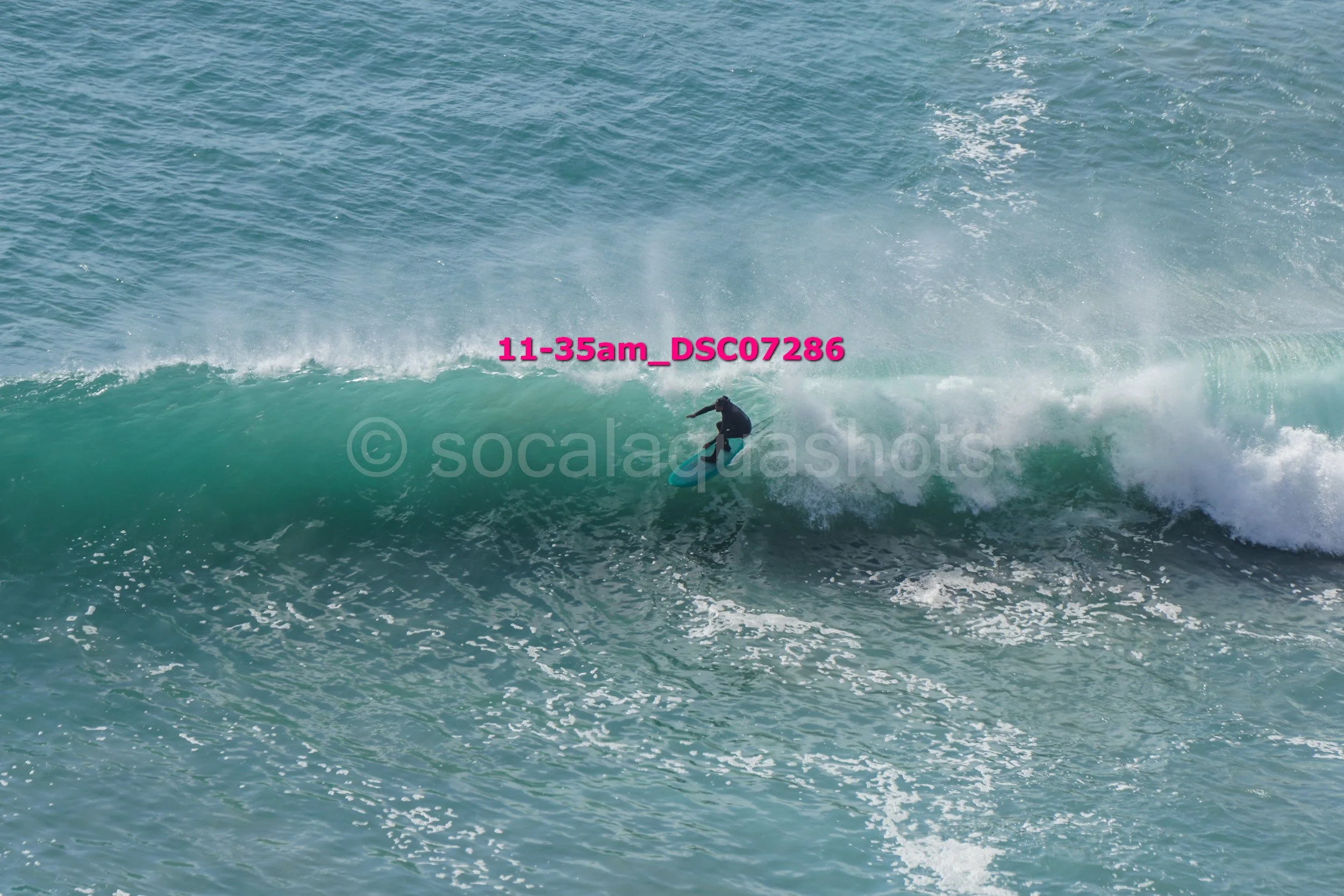 A person surfing on a wave in the ocean.