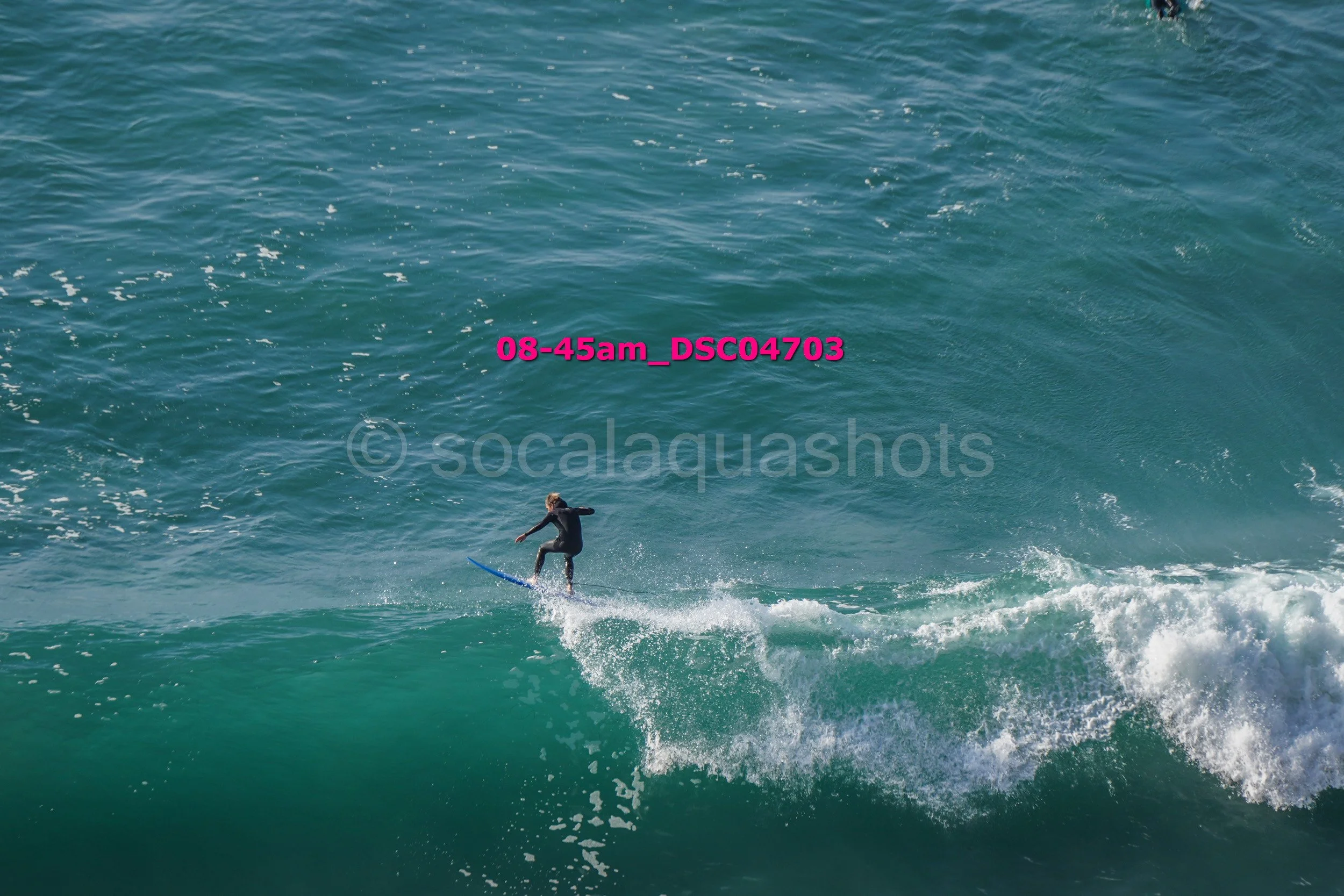 A person riding a wave on a surfboard in the ocean.