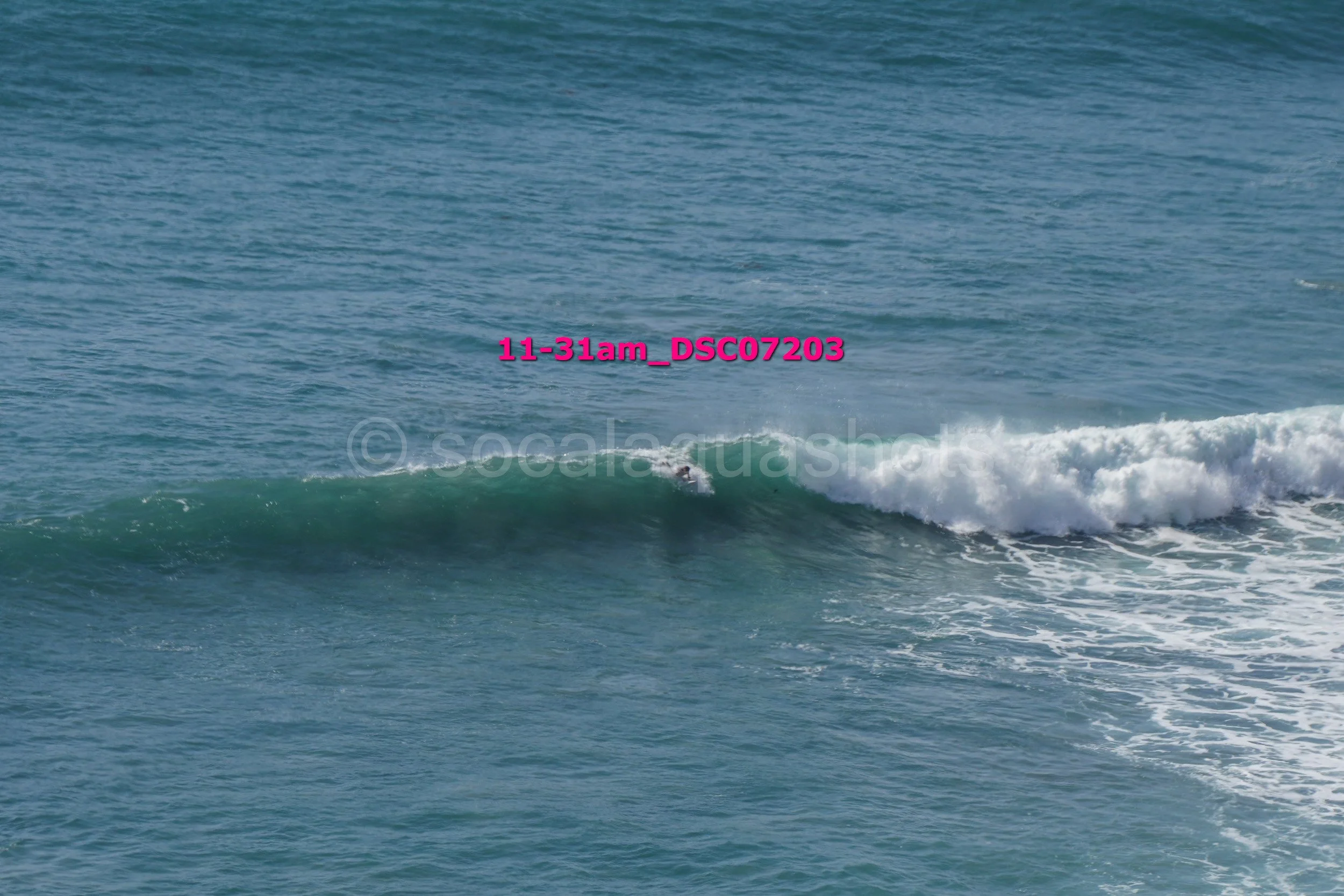 A person surfing on a wave in the ocean.