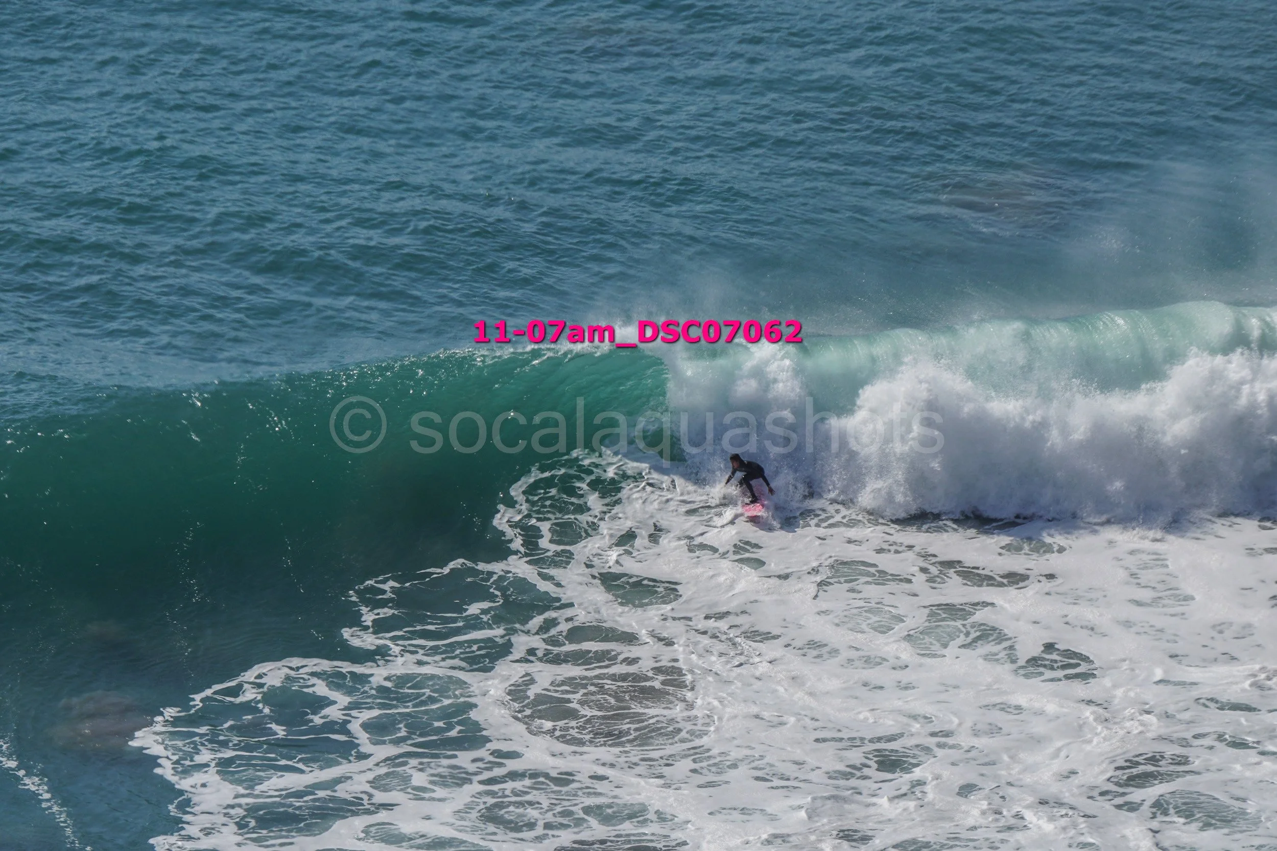 A person surfing on a wave in the ocean.