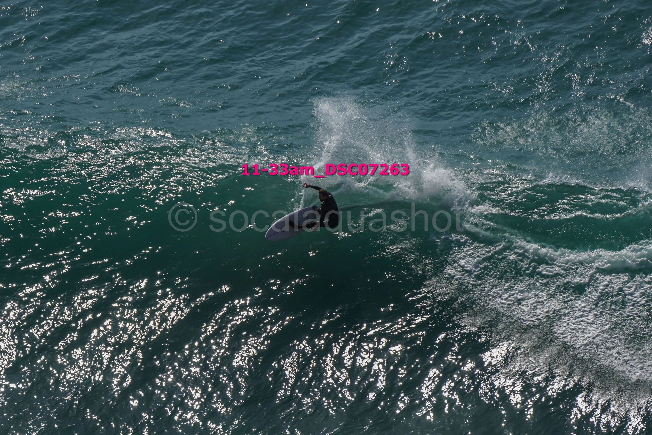 A person surfing on a wave in the ocean during daylight.