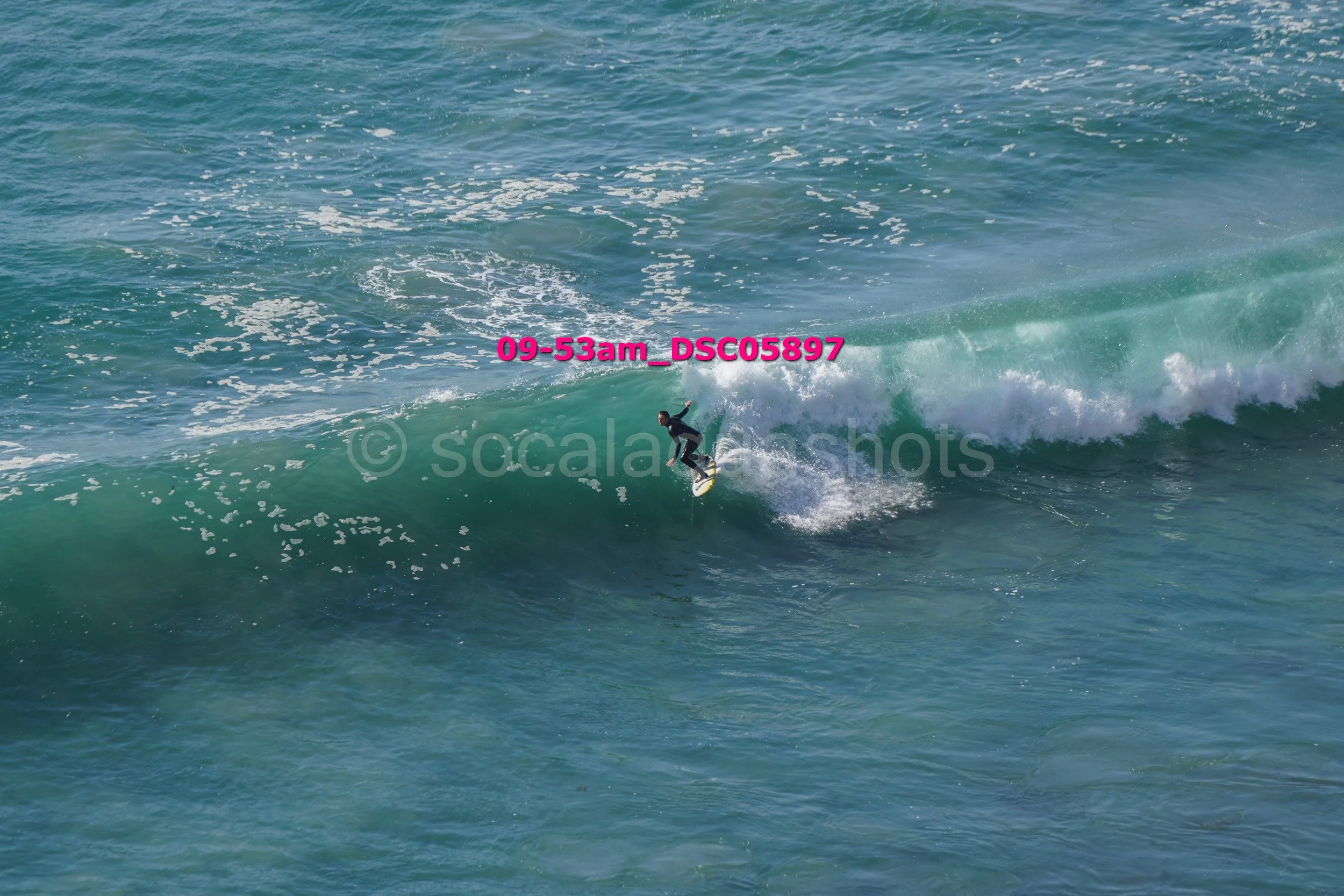 A person surfing on a wave in the ocean.