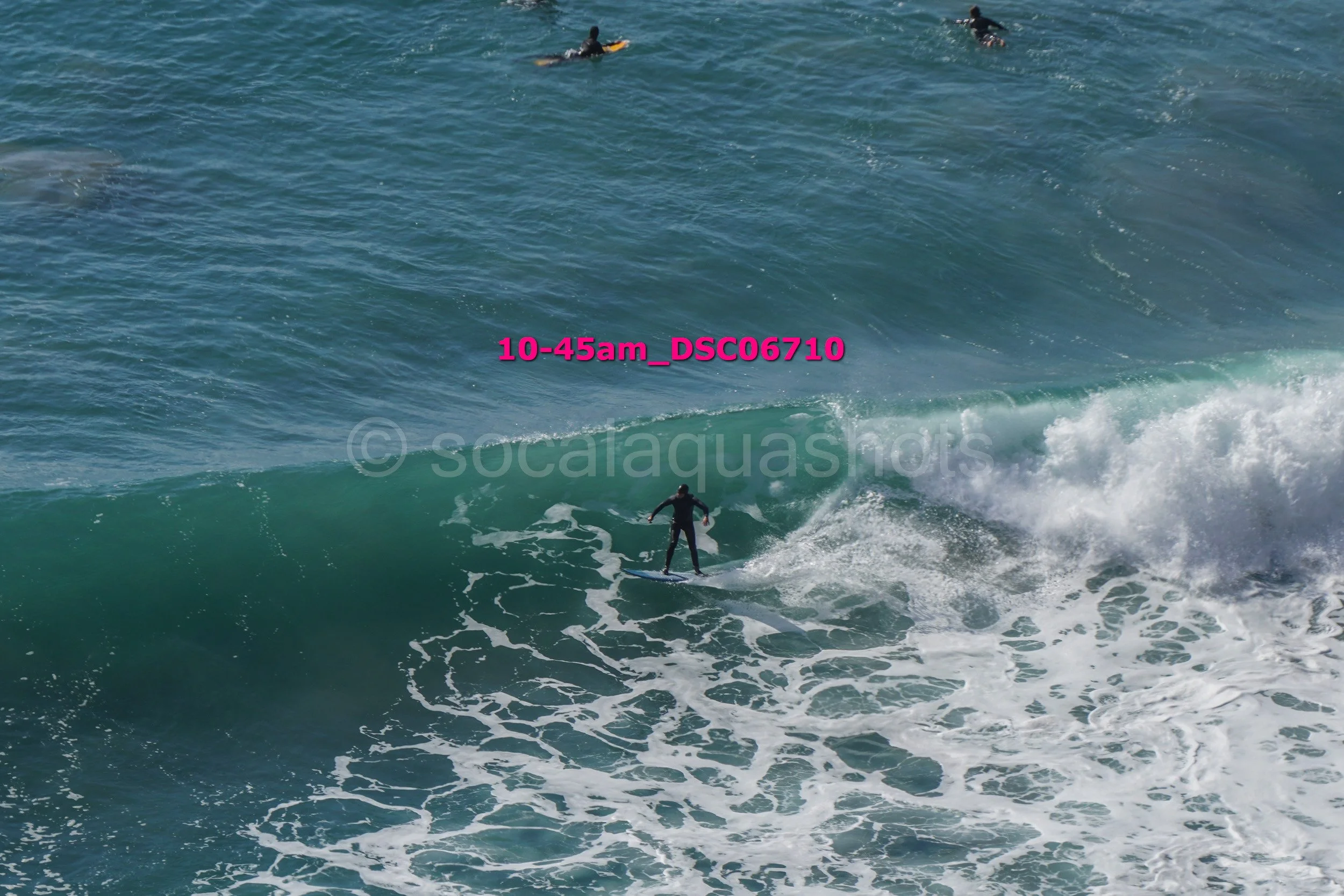 A person surfing on a wave in the ocean during the daytime