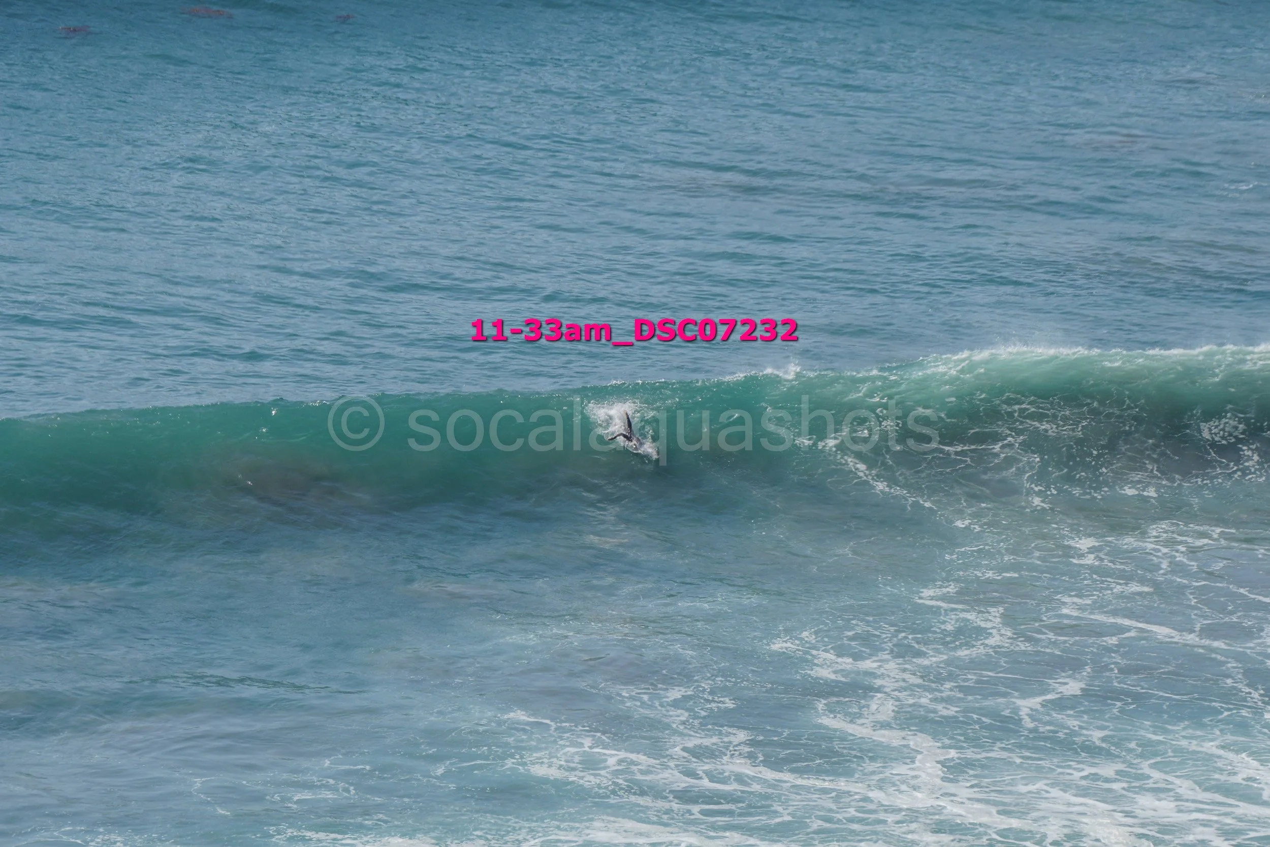 A surfer in black wetsuit riding a wave in the ocean
