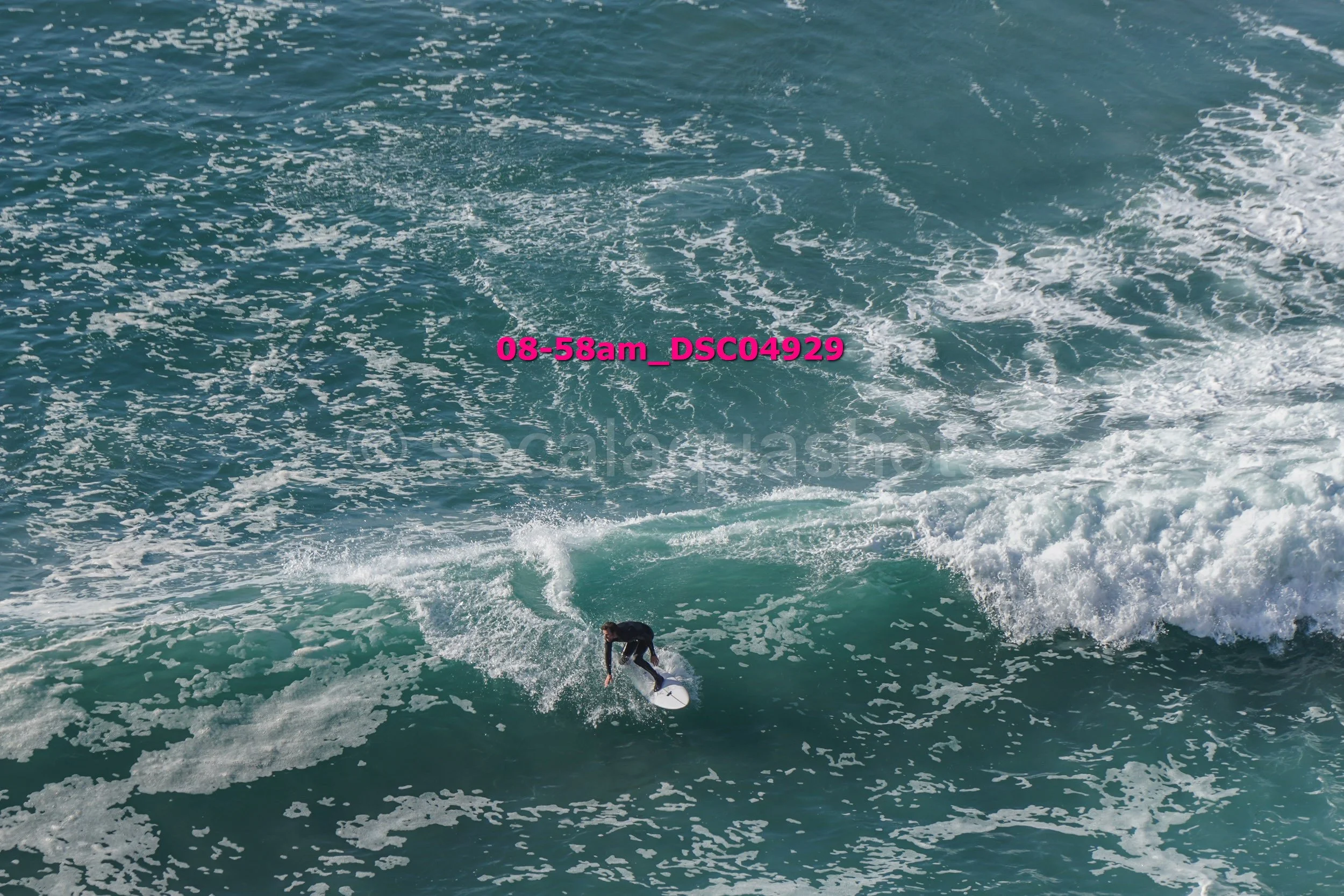 A person surfing on a wave in the ocean.