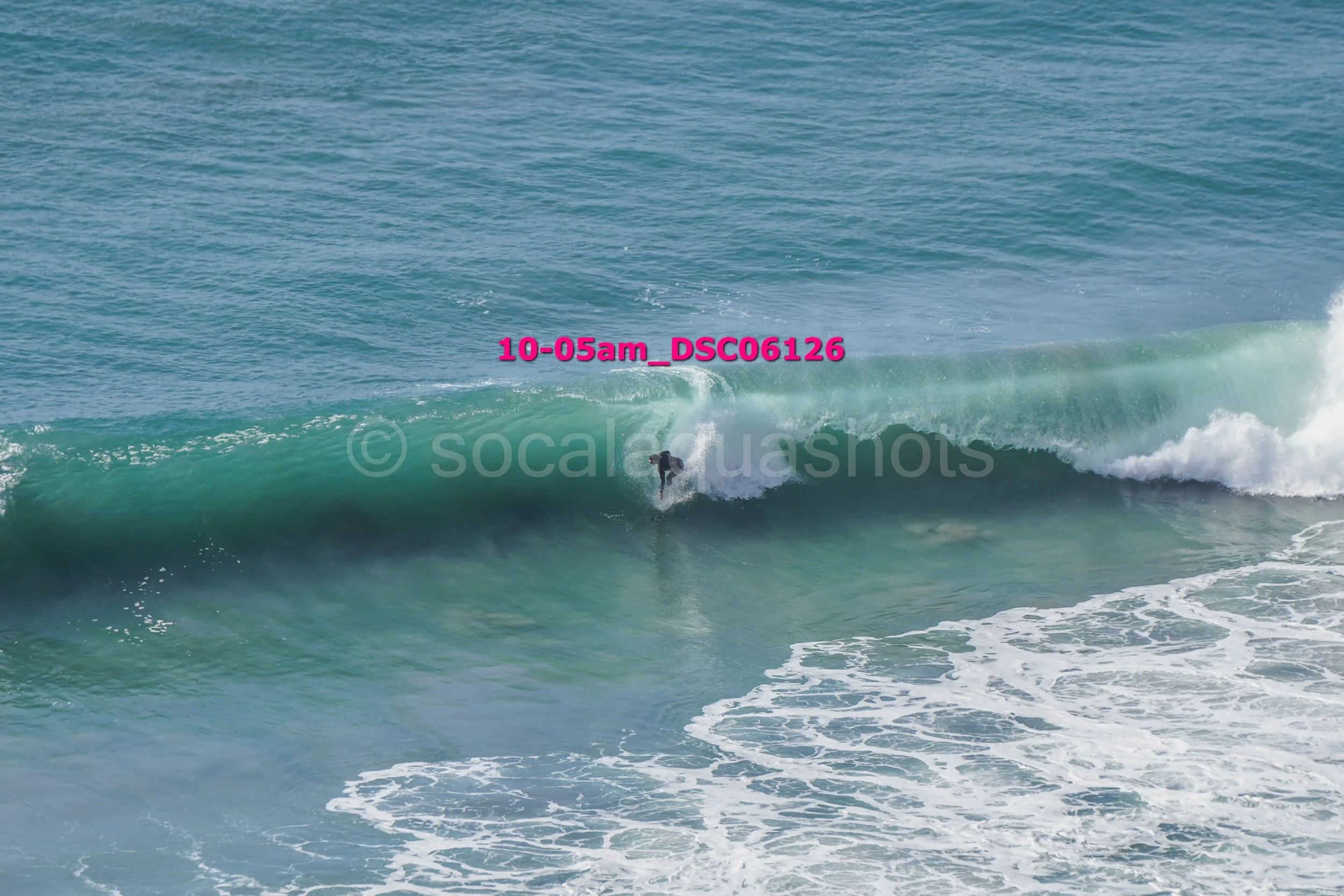 A person surfing on a large wave in the ocean