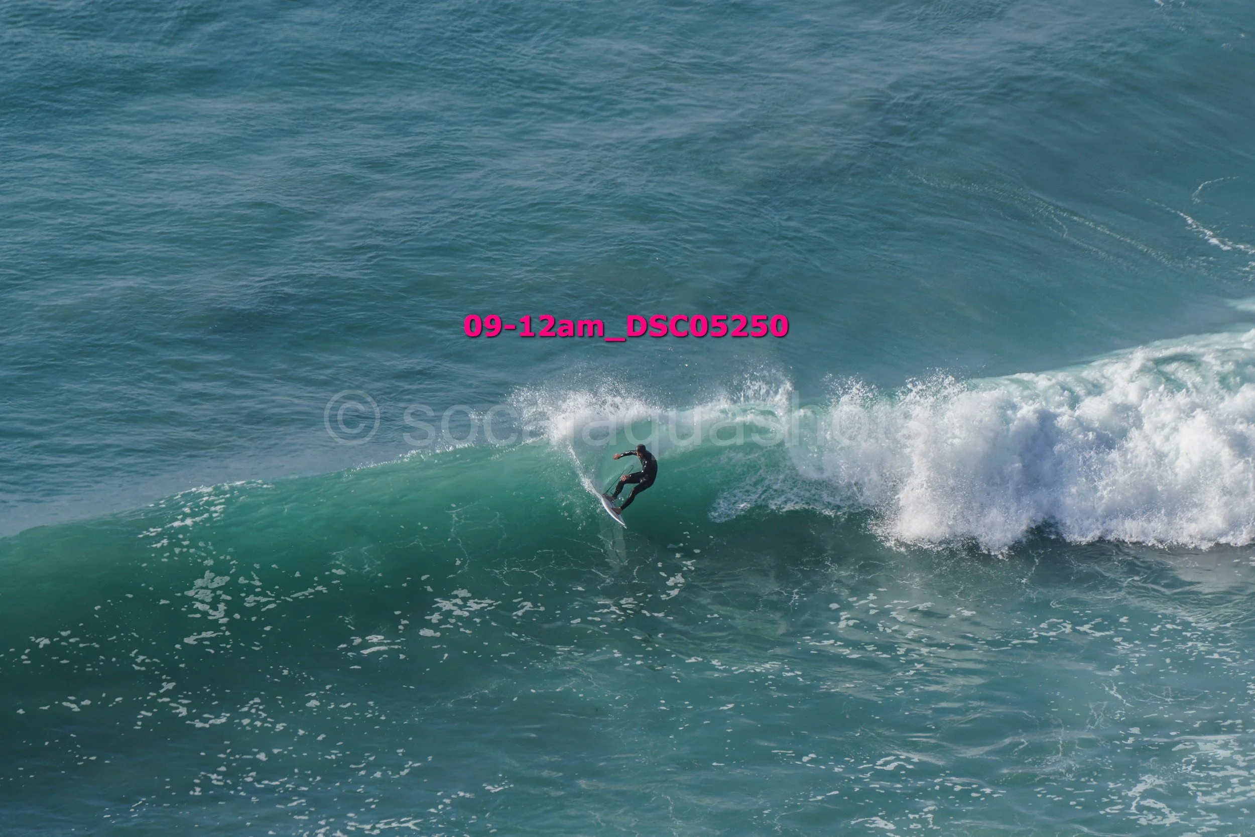 A person surfing on a wave in the ocean during daytime.