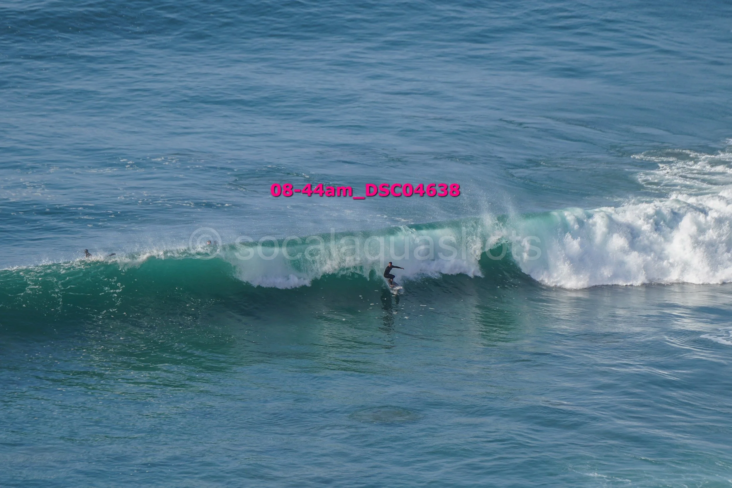 A person surfing on a wave in the ocean.