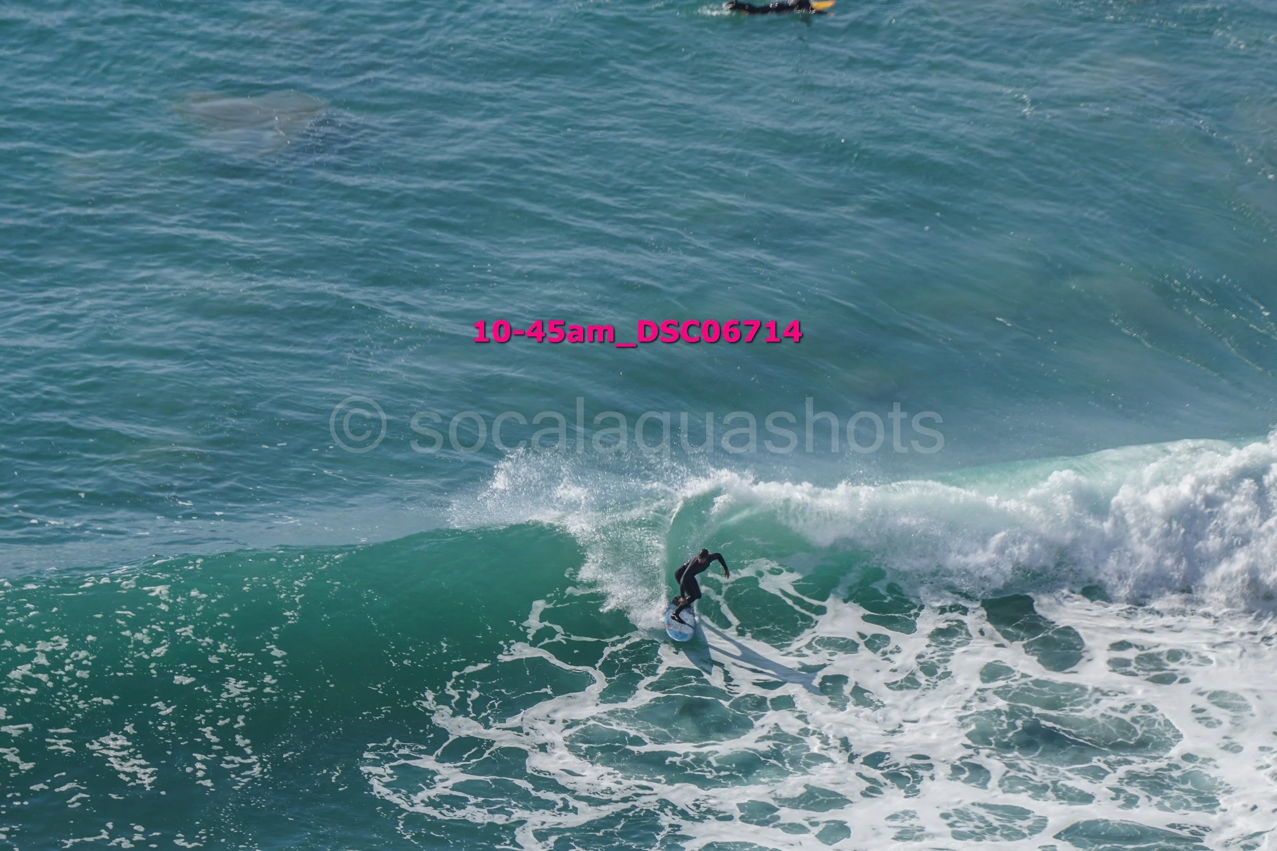 A person surfing on a wave in the ocean.