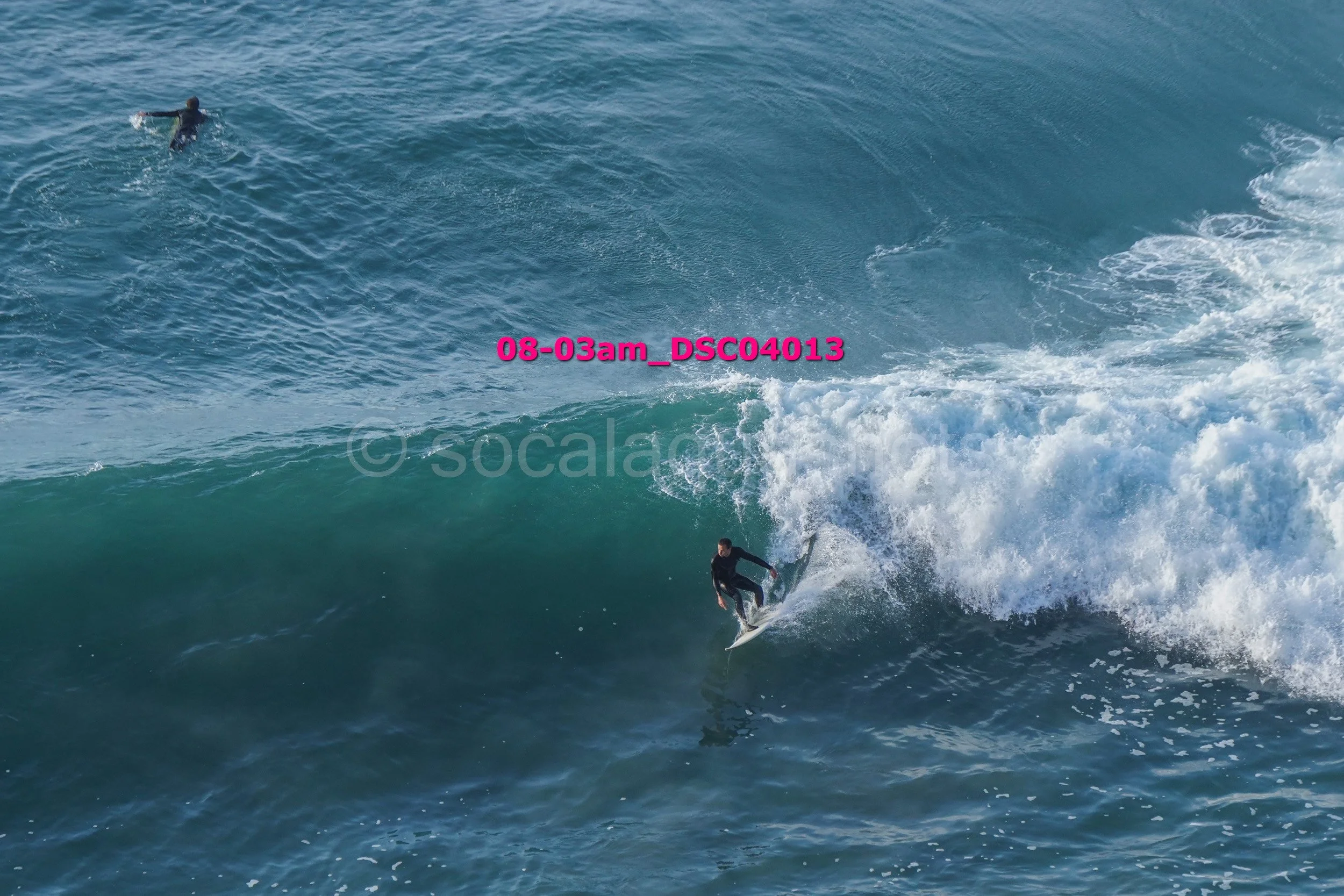 A person surfing on a wave in the ocean.