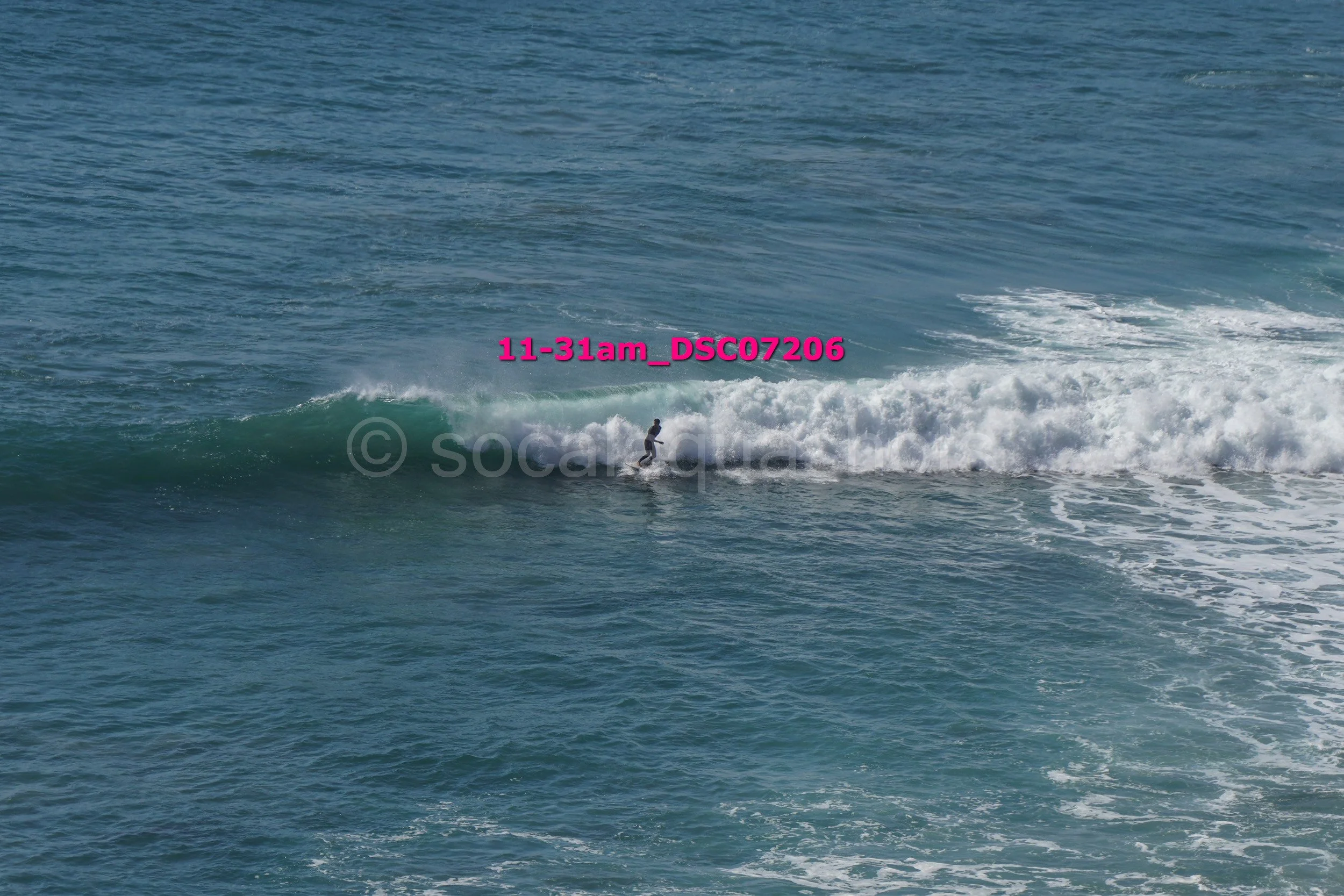 A person surfing on a wave in the ocean during daytime