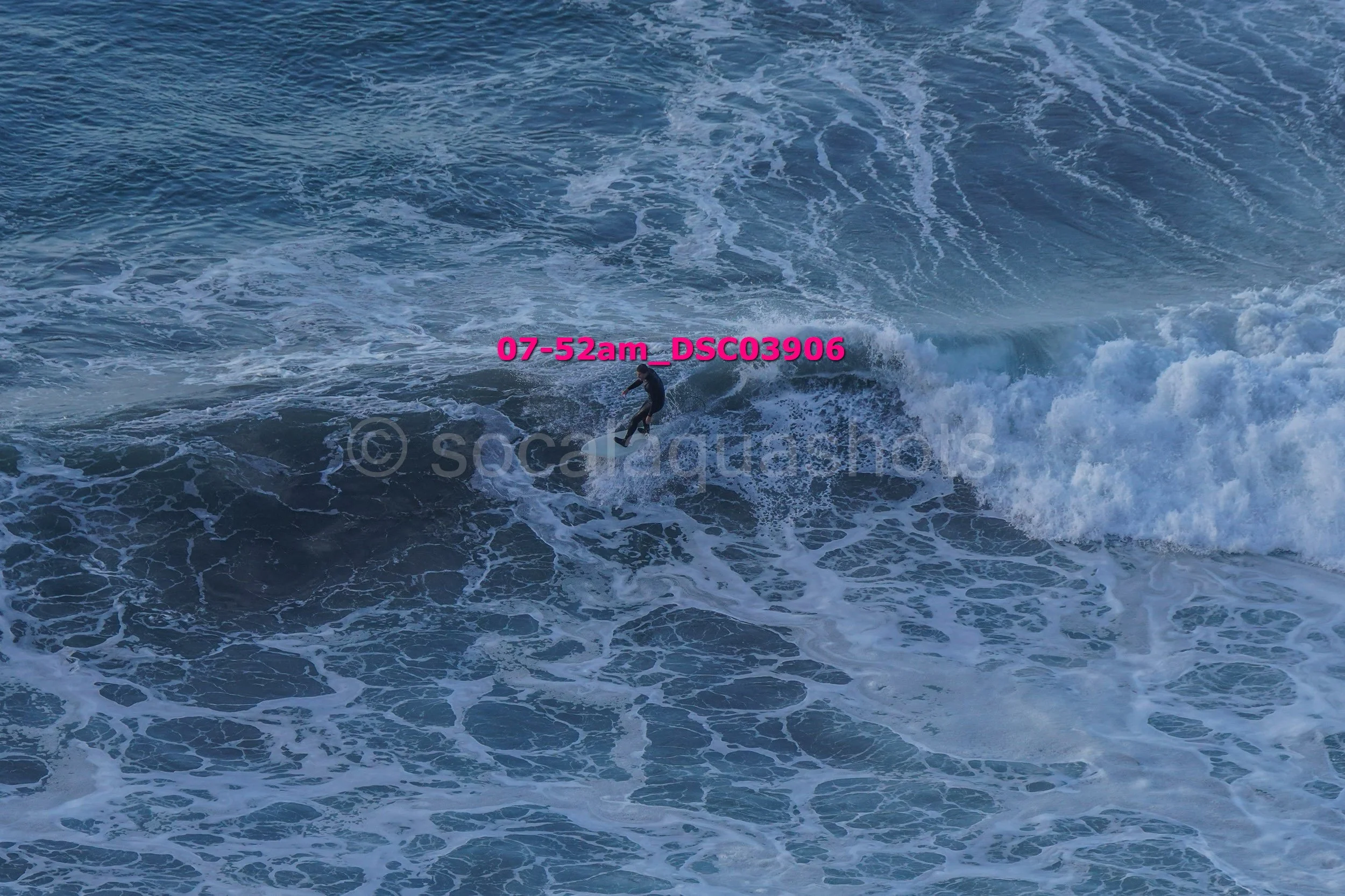 A person surfing on a wave in the ocean.