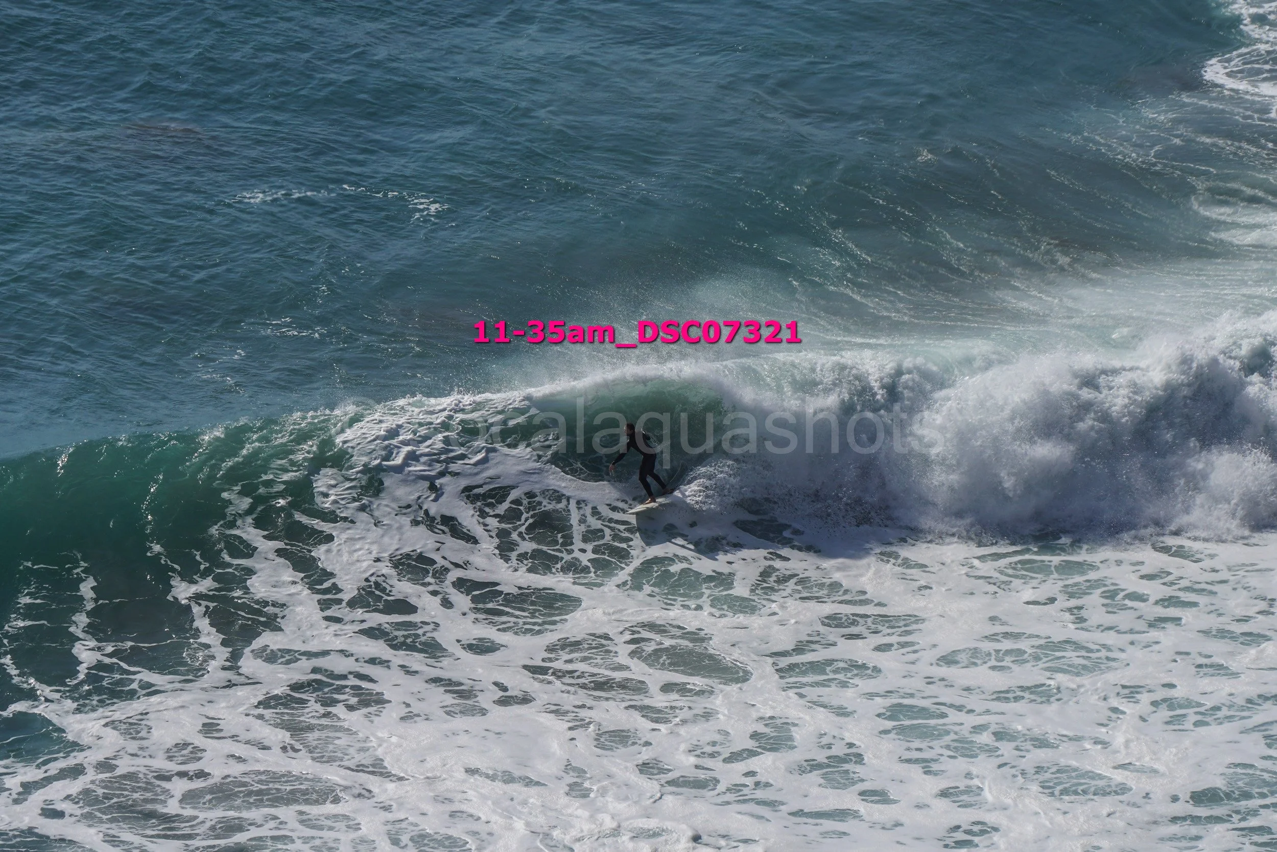 A person surfing on a wave in the ocean.