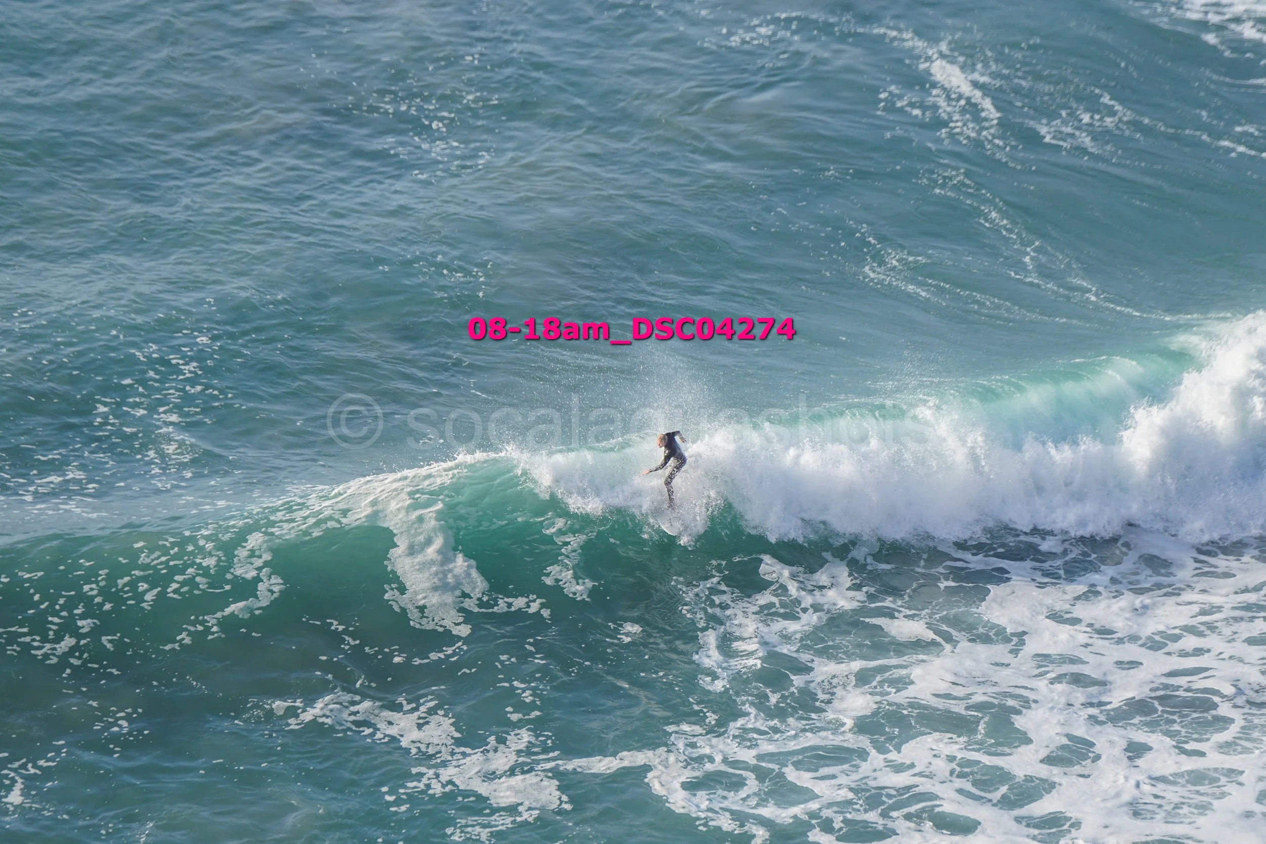 A person surfing on a wave in the ocean