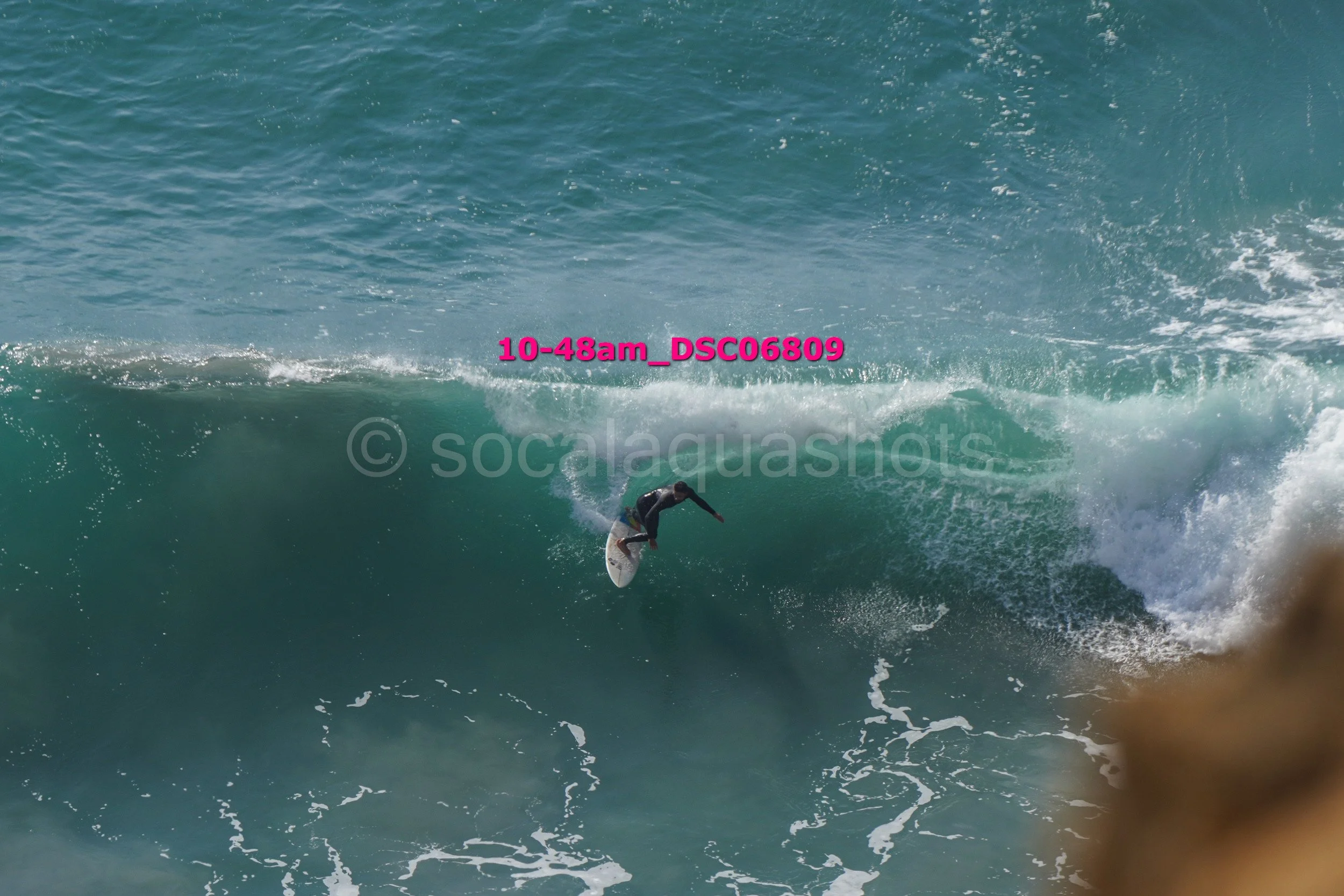 A surfer riding a large wave in the ocean.
