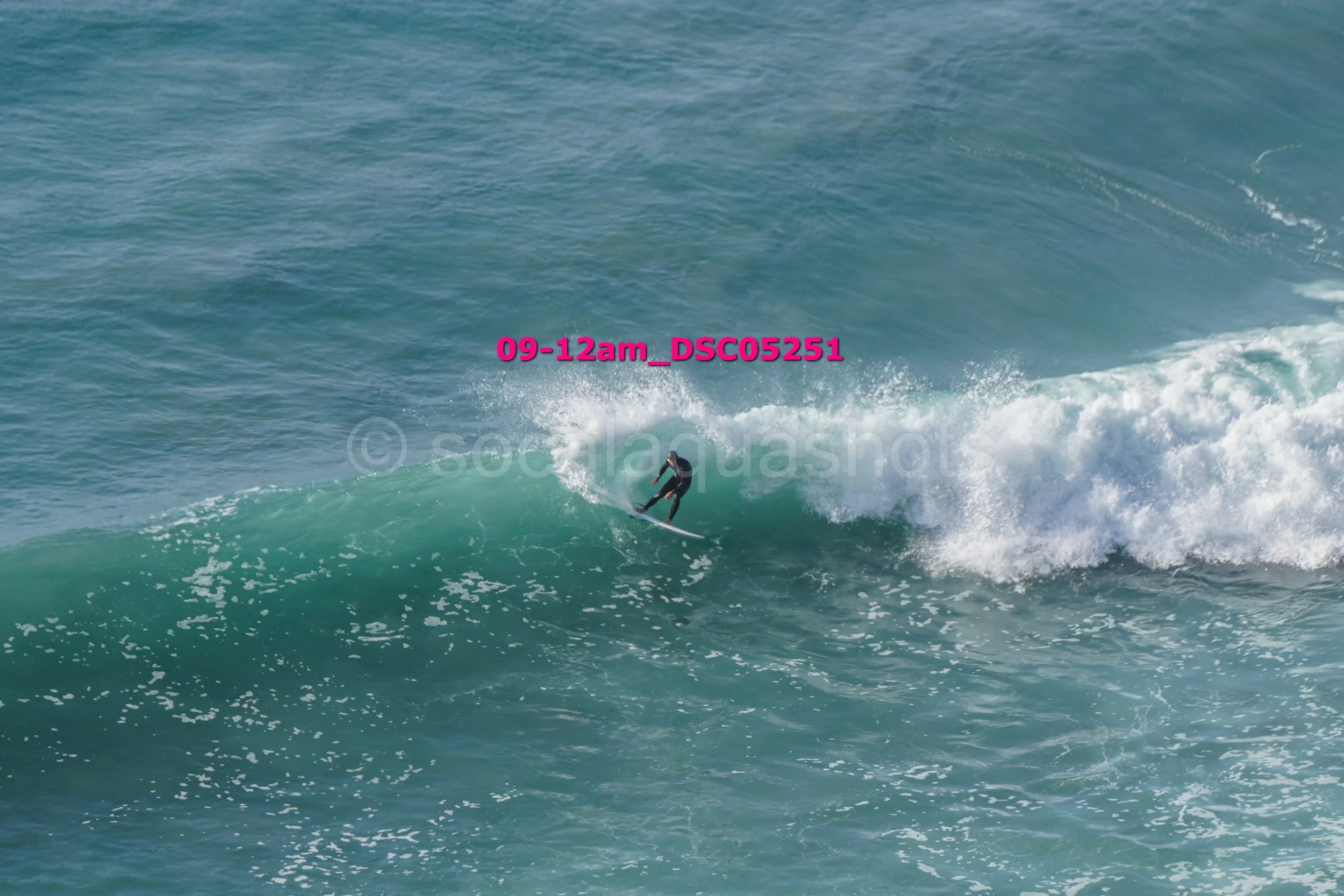 A person surfing on a wave in the ocean during daytime.