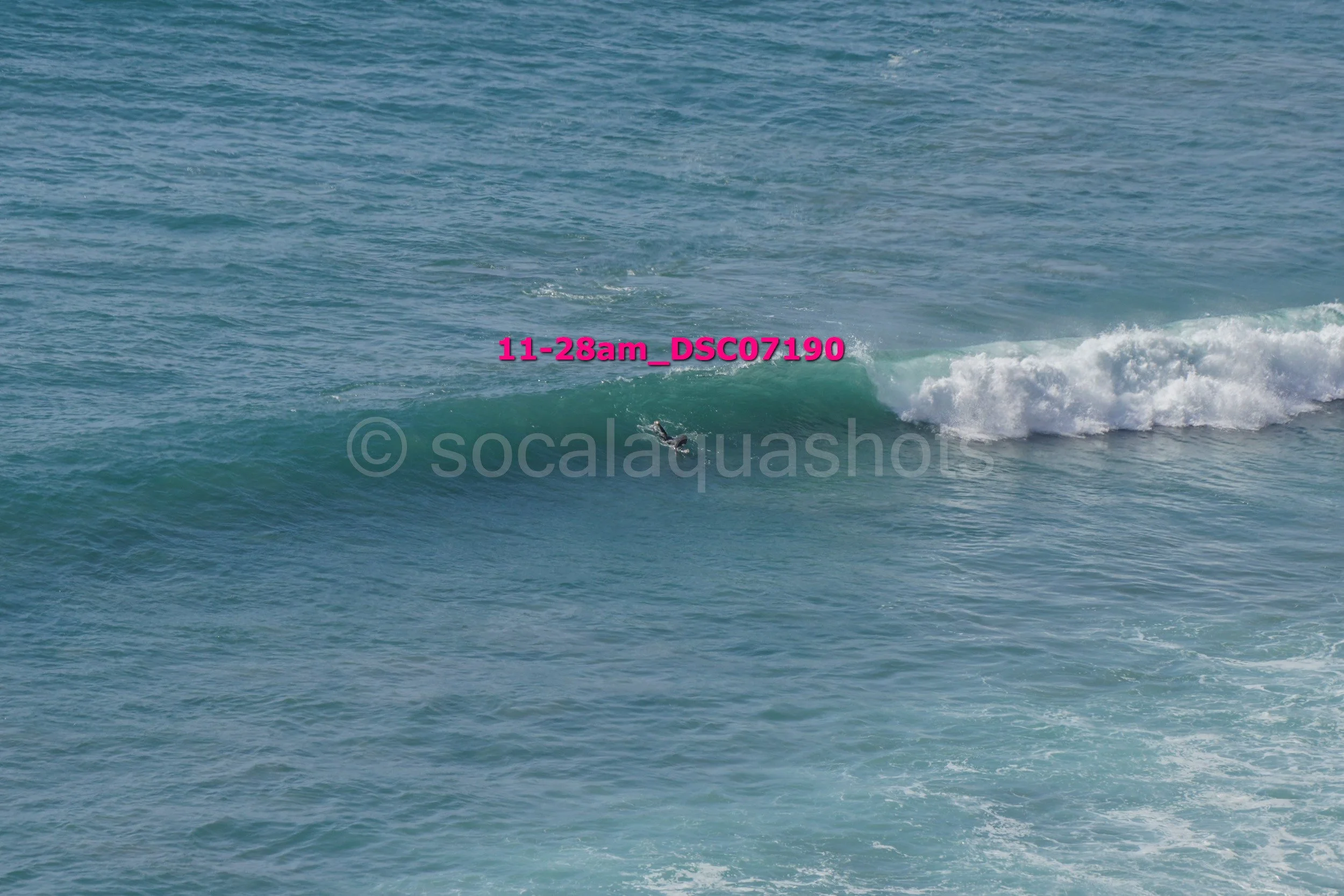 A person surfing on a wave in the ocean.
