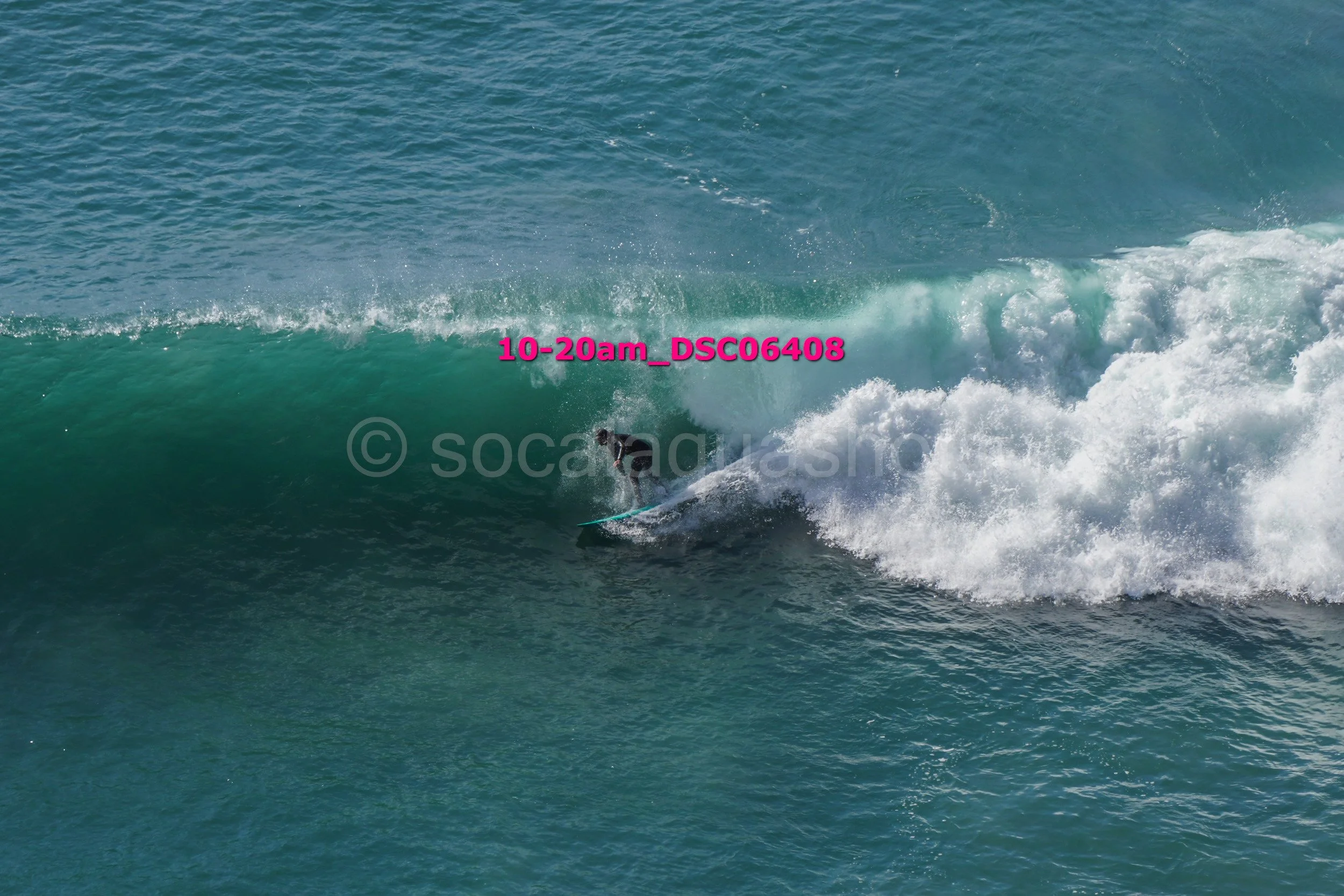 A person surfing on a wave in the ocean, with water splashing around them.