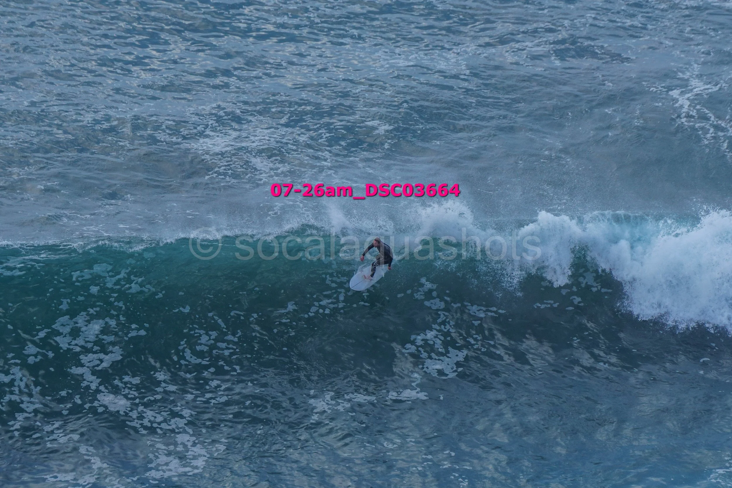 A person surfing on a wave in the ocean.