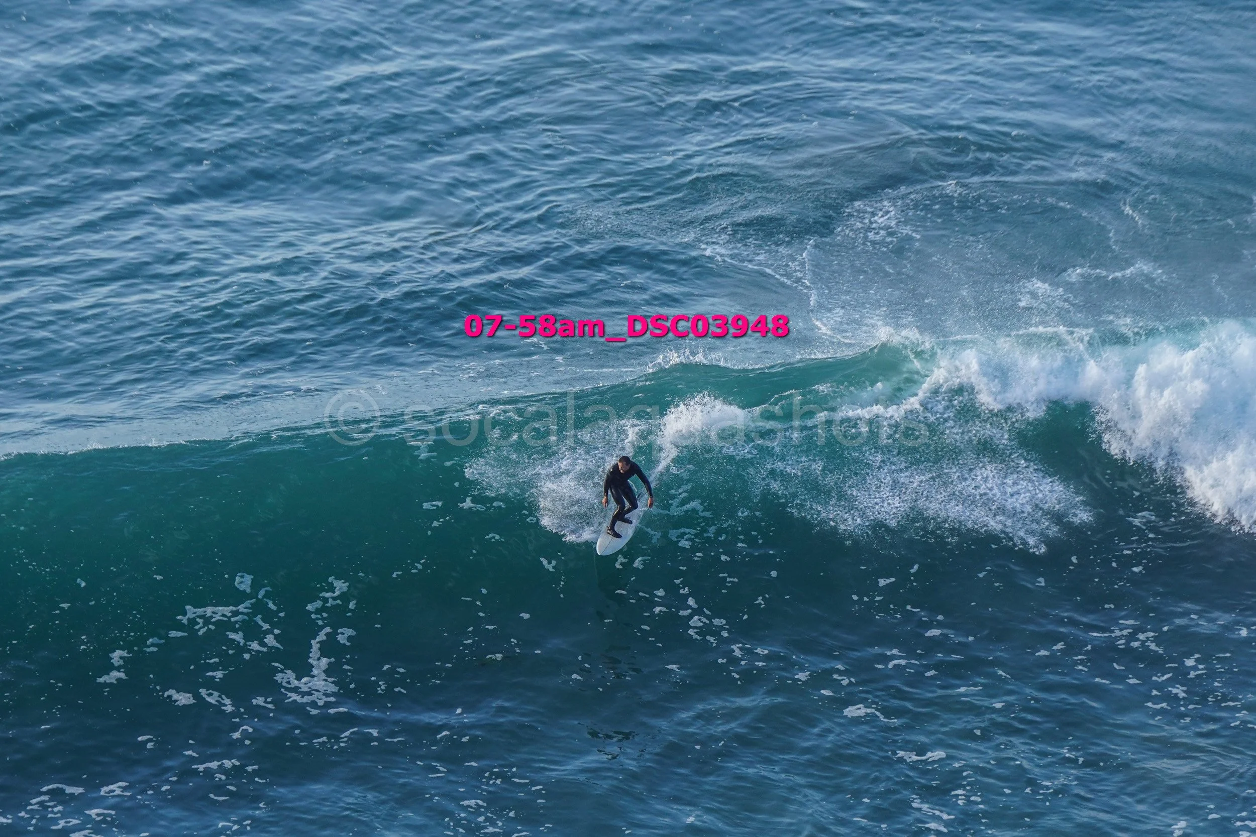 A person surfing on a wave in the ocean.
