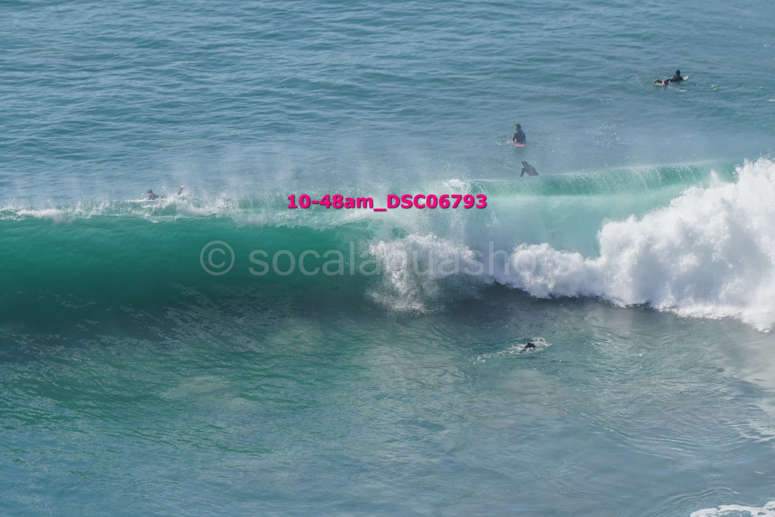 People surfing in the ocean with large waves.