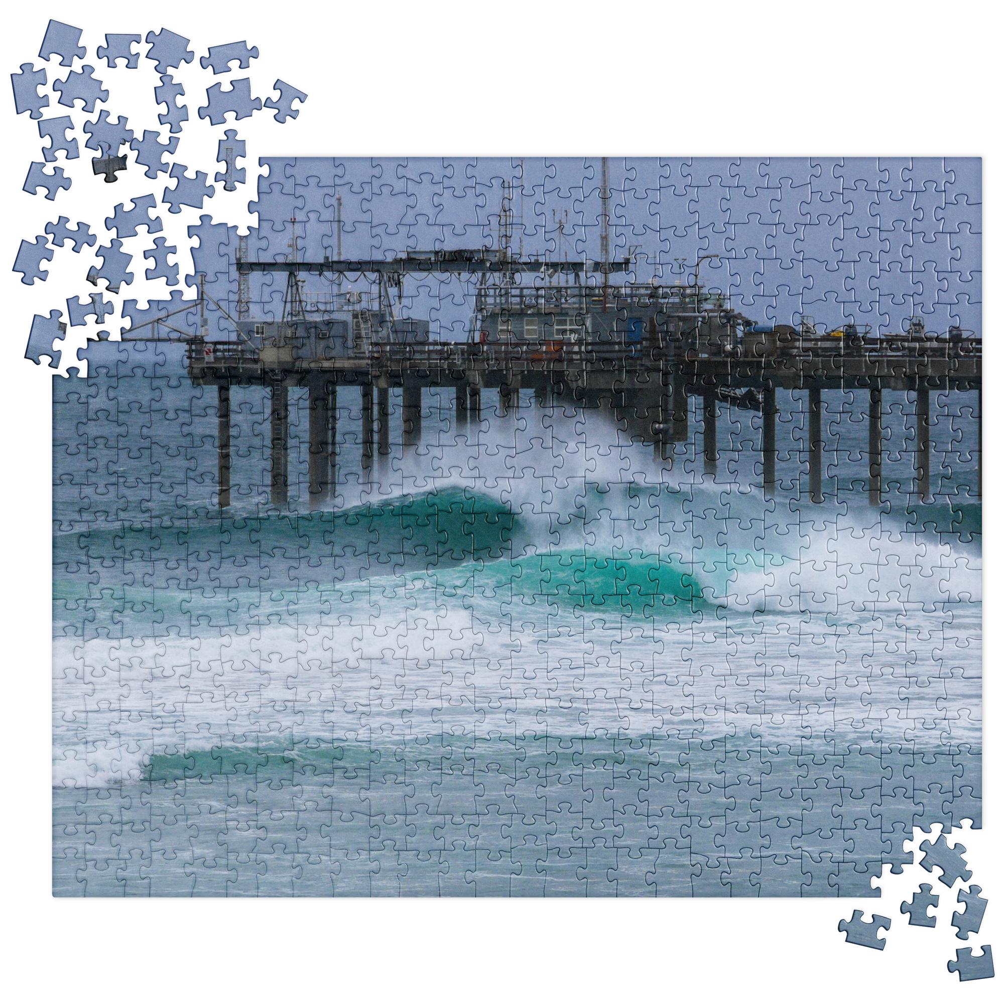 Unfinished jigsaw puzzle depicting an ocean pier with waves crashing in the foreground and a pile of loose pieces in the corners.