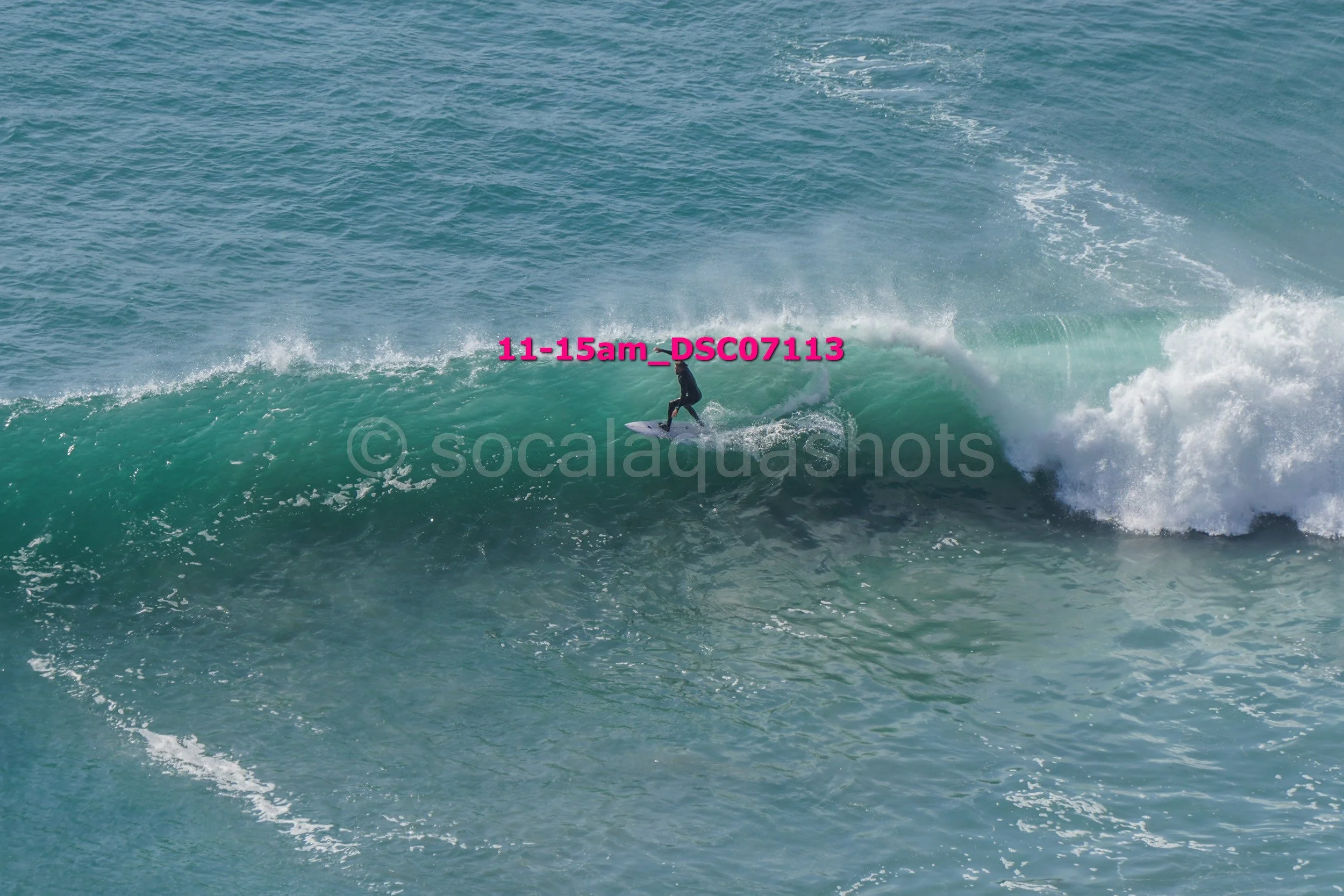 A person surfing on a wave in the ocean.