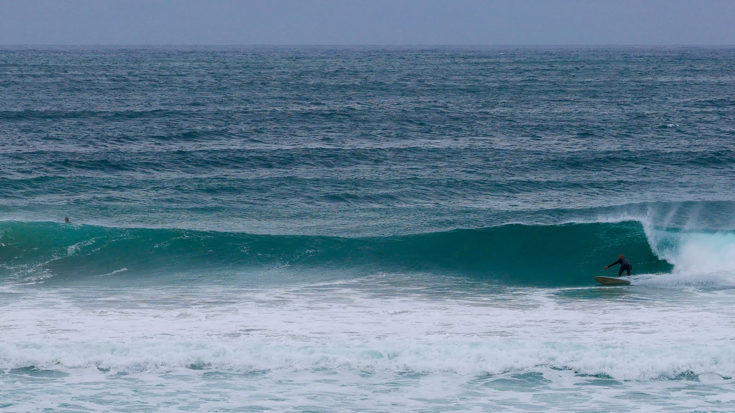 Surfer riding a wave in the ocean