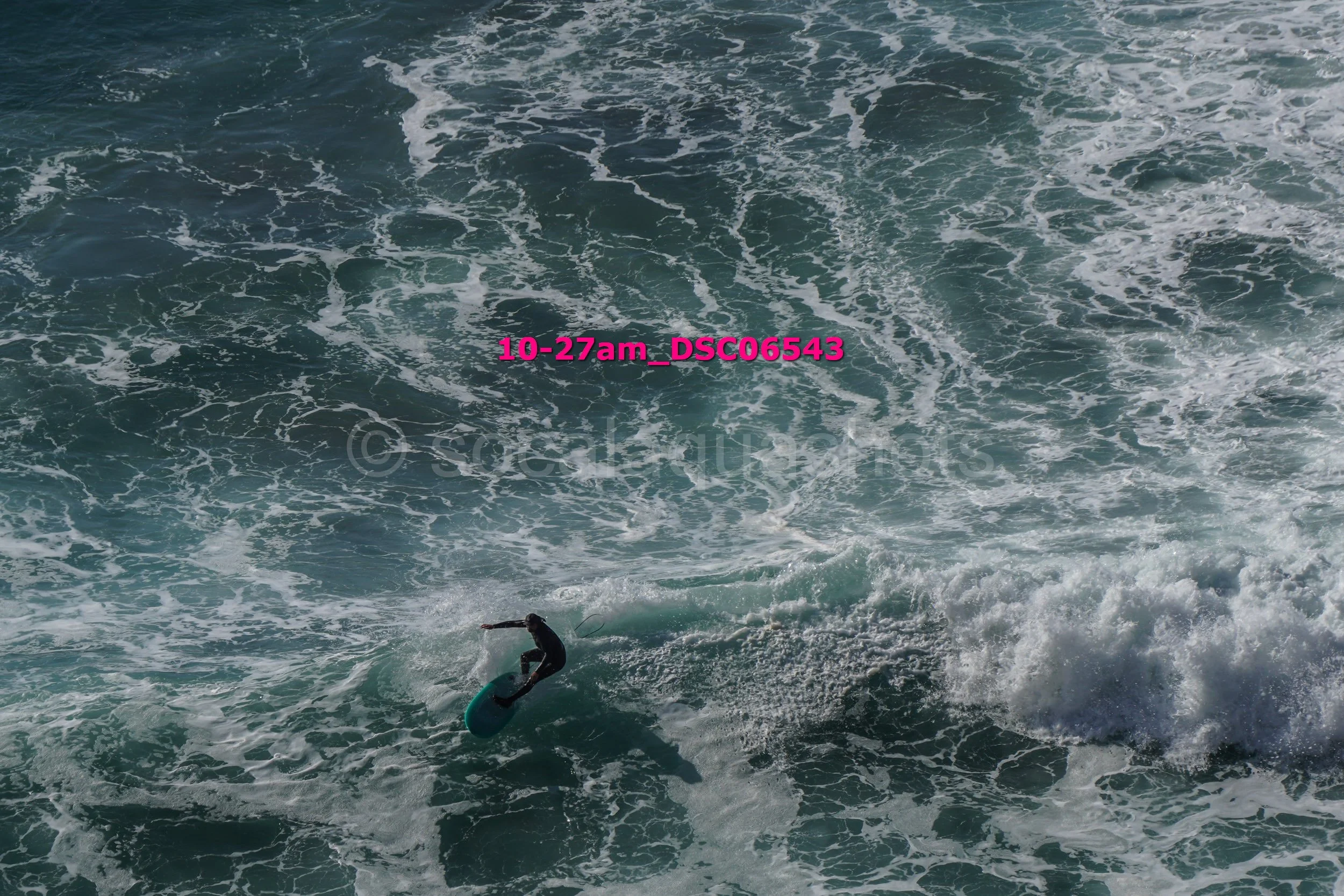 A person surfing on a wave in the ocean.