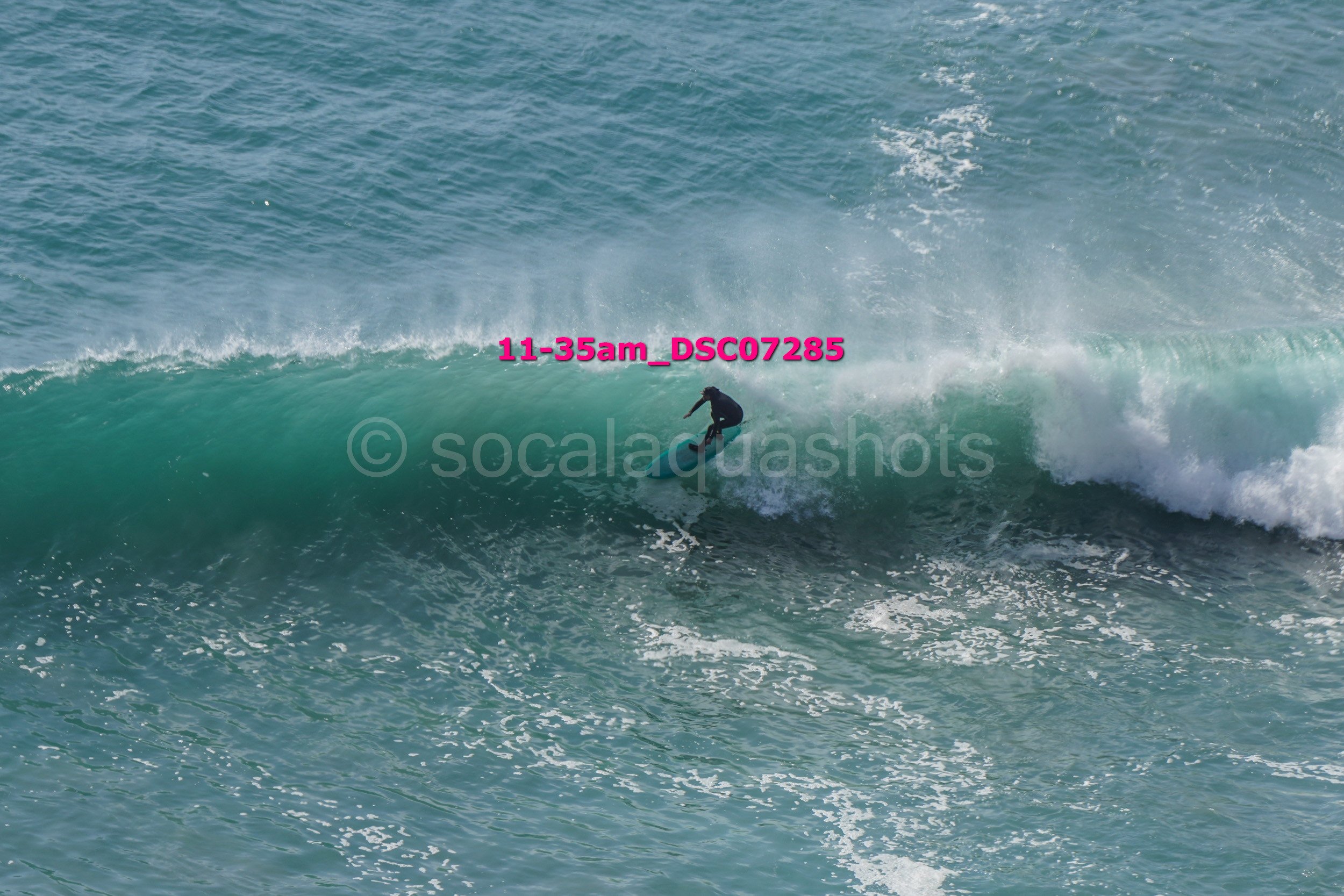 A person surfing on a wave in the ocean.
