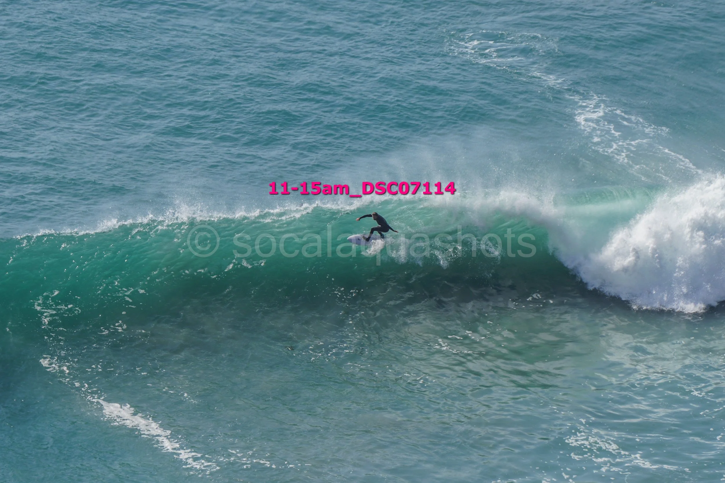A surfer riding a large wave in the ocean.