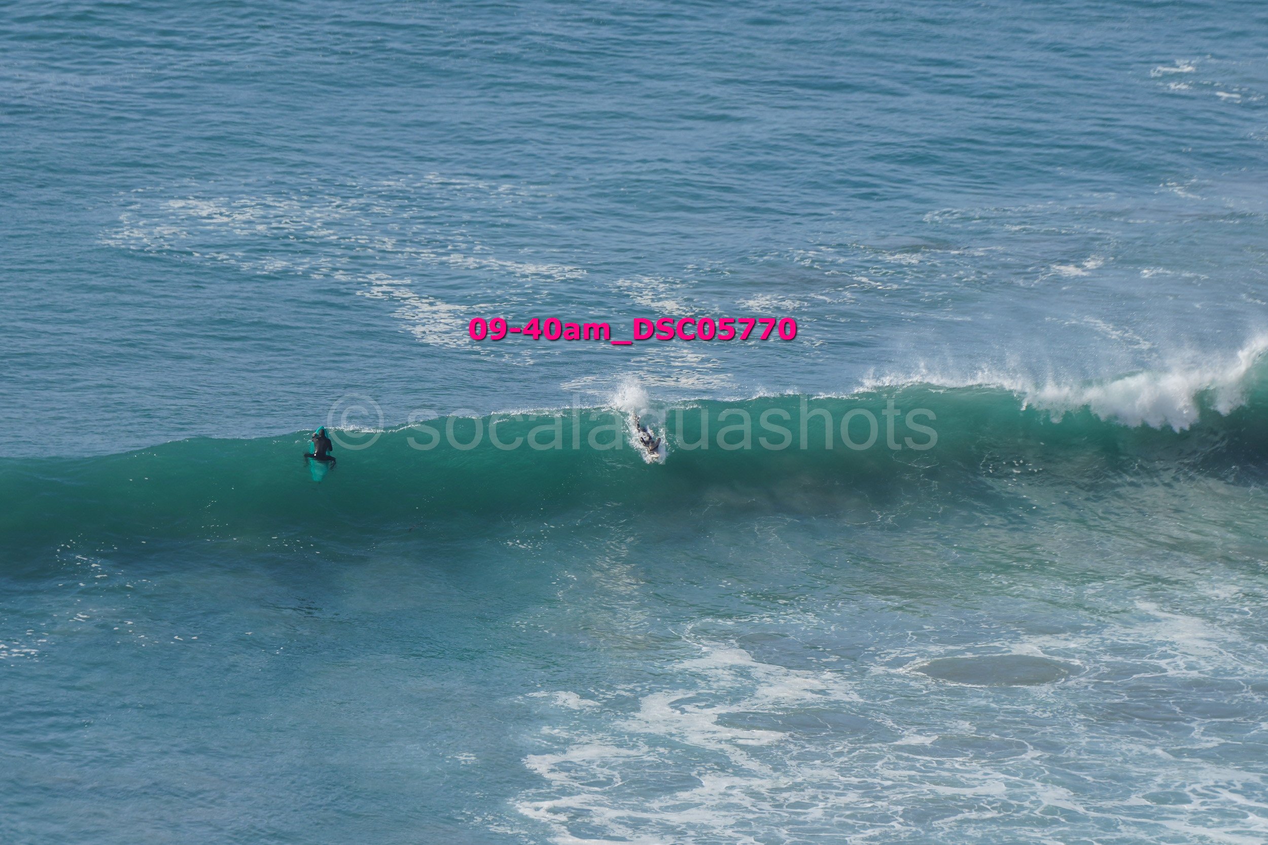 A person surfing on a wave in the ocean during daytime.